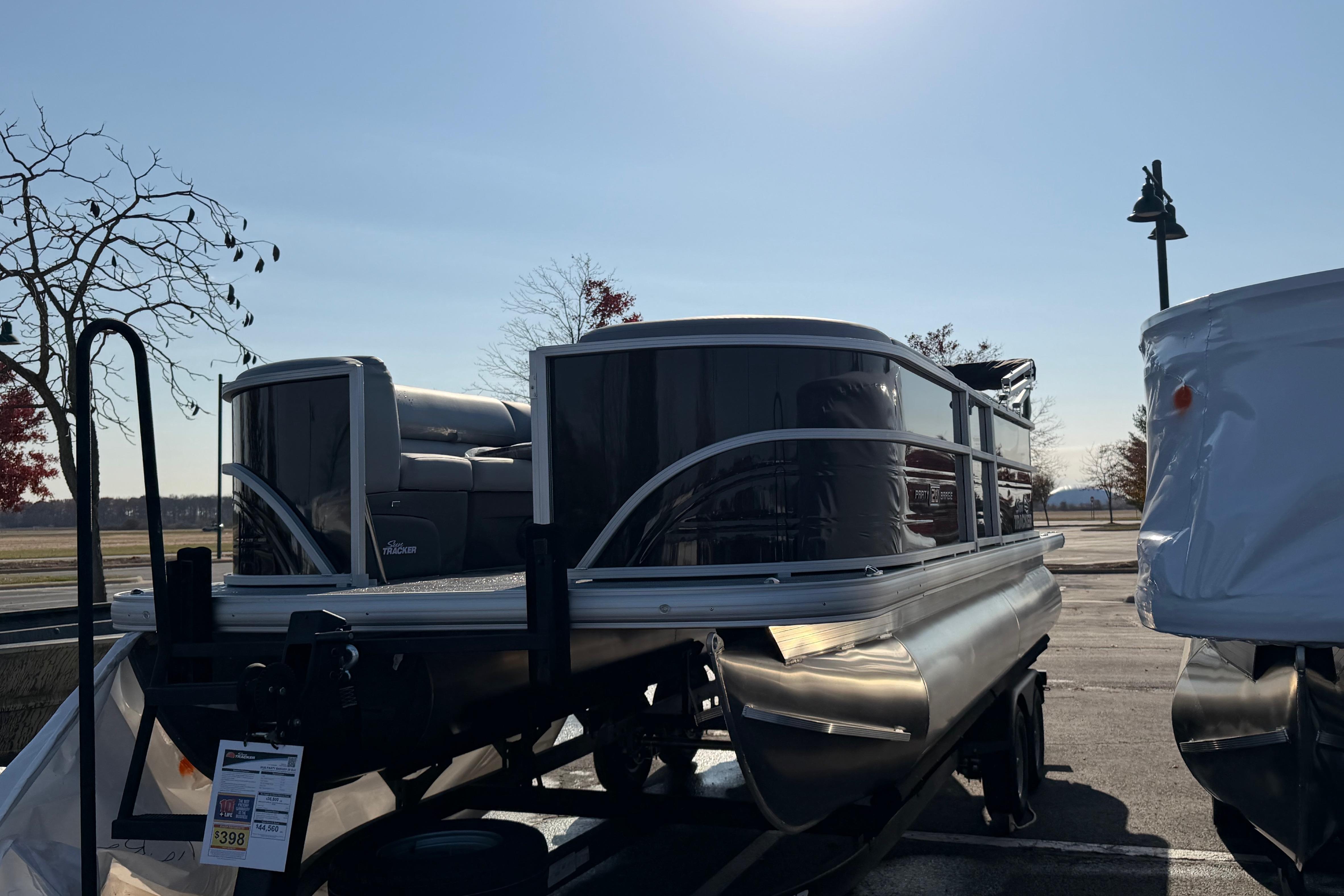 2026 Sun Tracker Party Barge 20 DLX pontoon boat parked outdoors.
