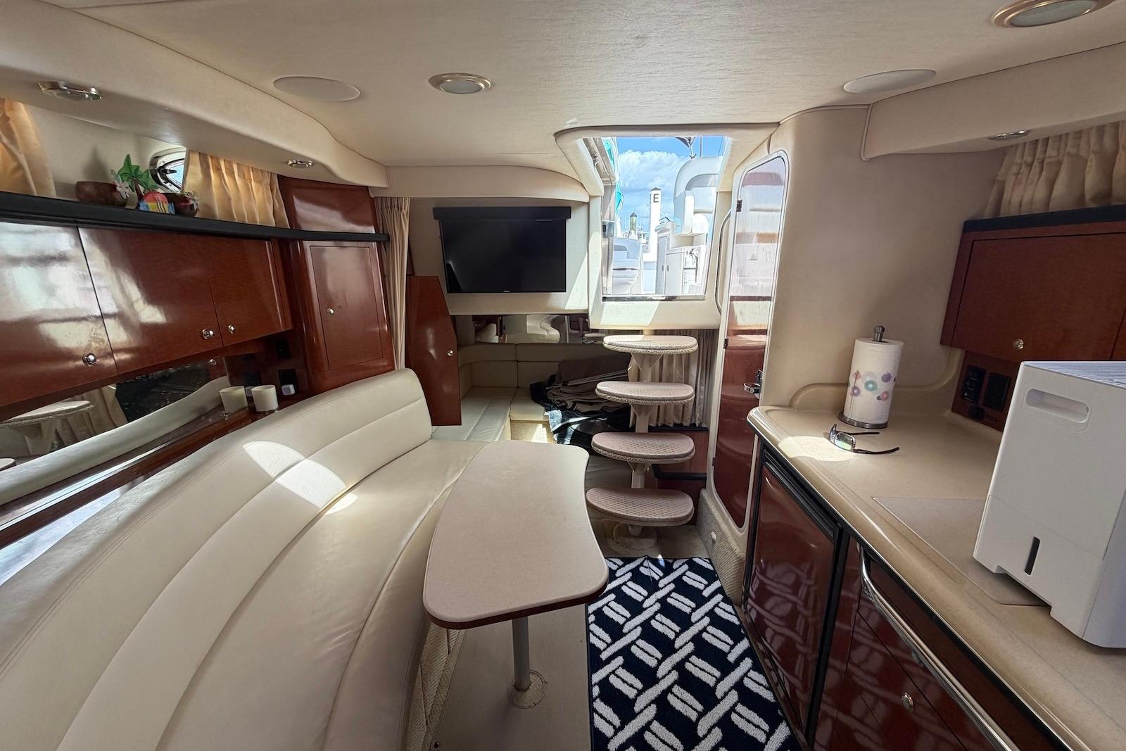 Luxurious interior of a 2003 Sea Ray 340 Sundancer yacht with elegant seating and cabinetry.