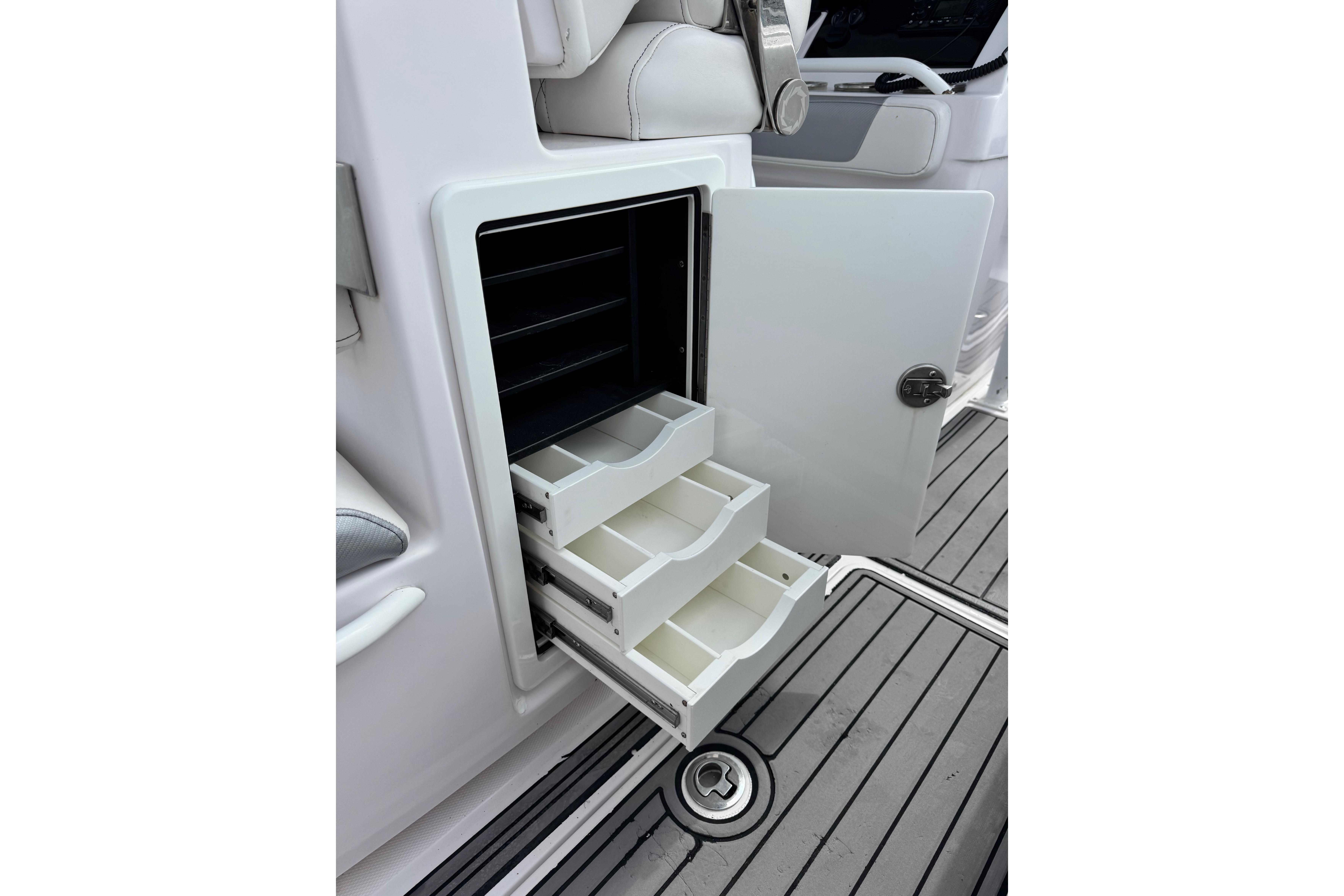 2018 Fountain 34 Center Console boat with open storage drawers on deck.
