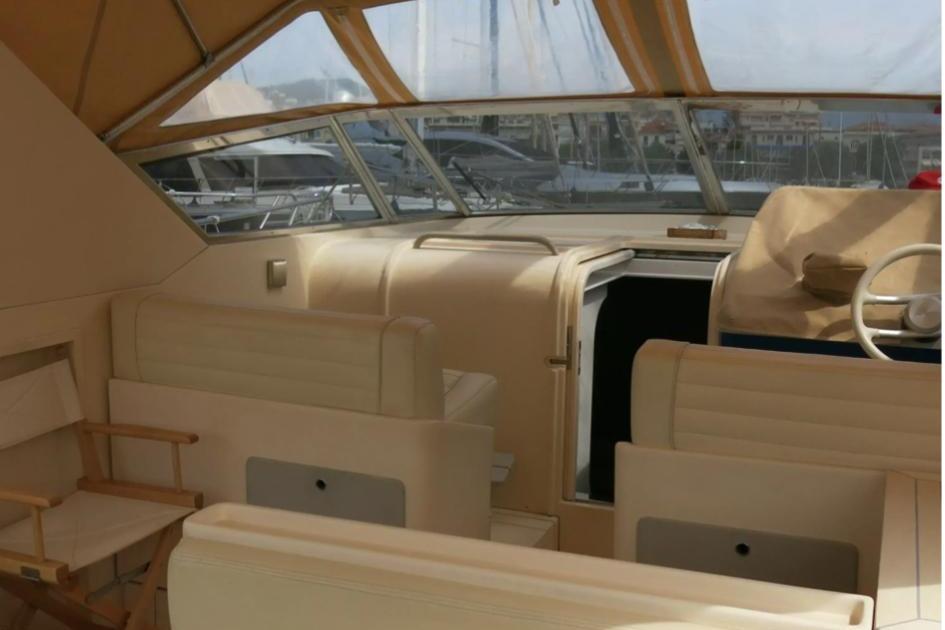 Interior of 1989 Riva TROPICANA 43 yacht with beige seating and helm.