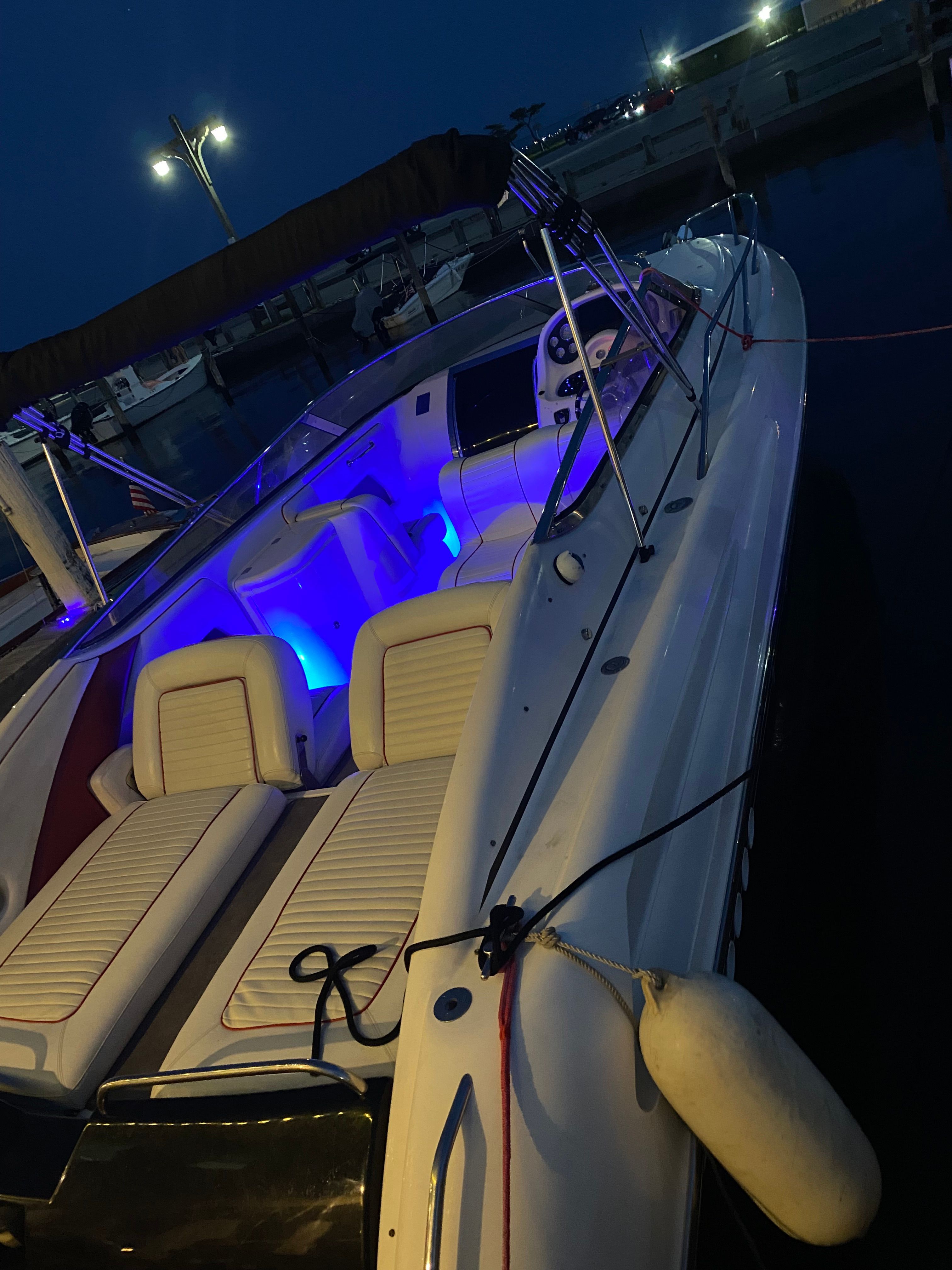 1994 Sunseeker Hawk 31 docked at night with blue lighting.