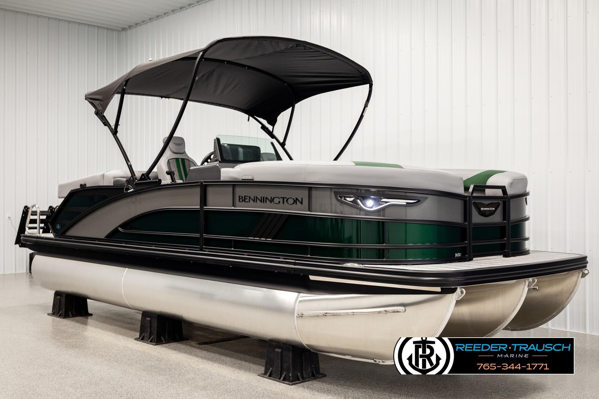 2026 Bennington MOFBSF pontoon boat with canopy in showroom.