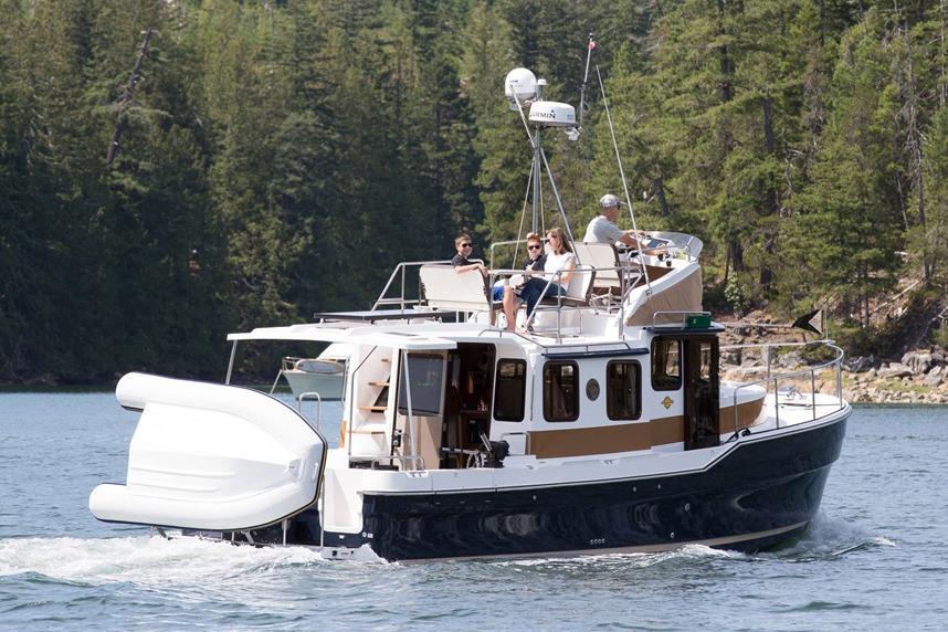 Manufacturer Provided Image: 2025 Ranger Tugs R-31 CB cruising on a scenic lake with lush forest backdrop.
