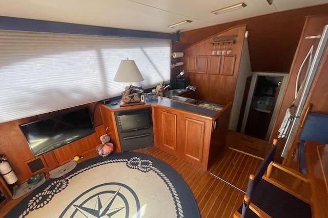 Interior of 1987 Topaz 44 Flybridge yacht with wood paneling and nautical decor.