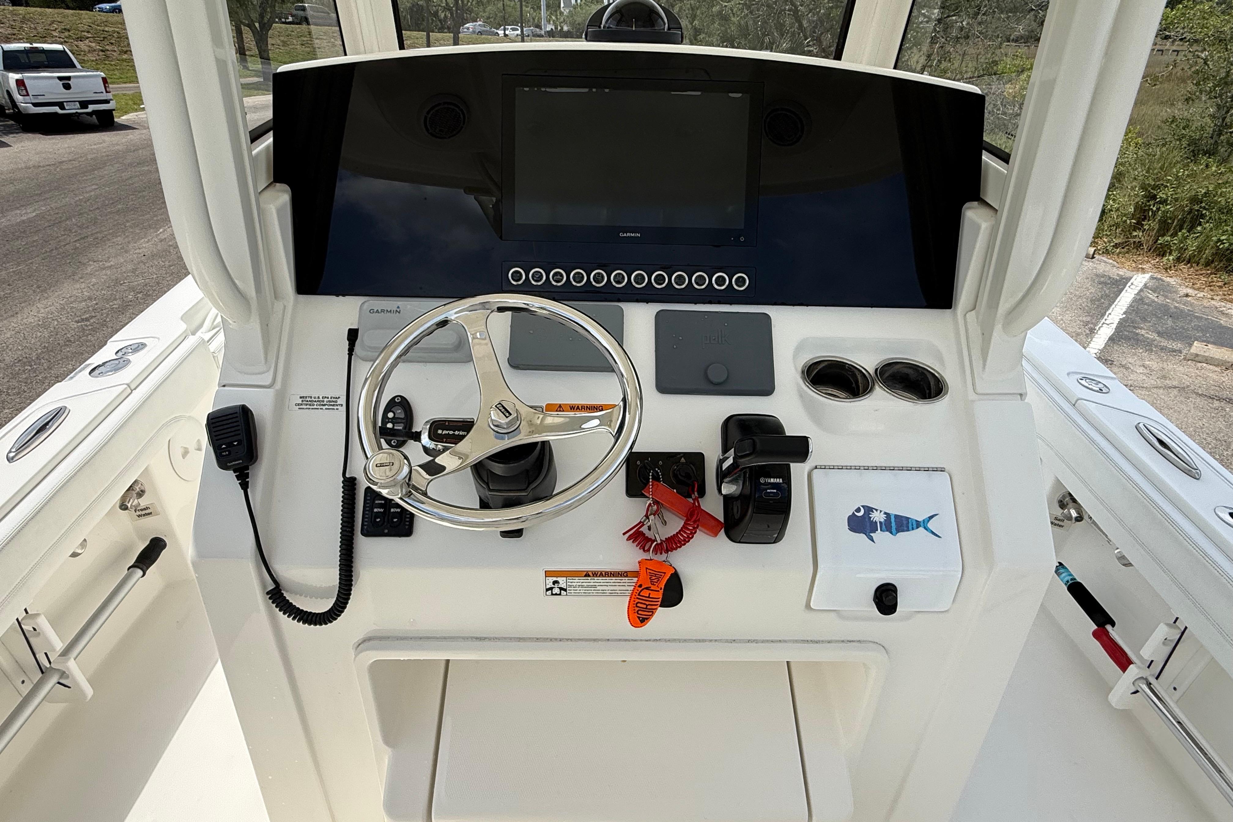 2019 Regulator 26XO boat helm with steering wheel, controls, and navigation display.