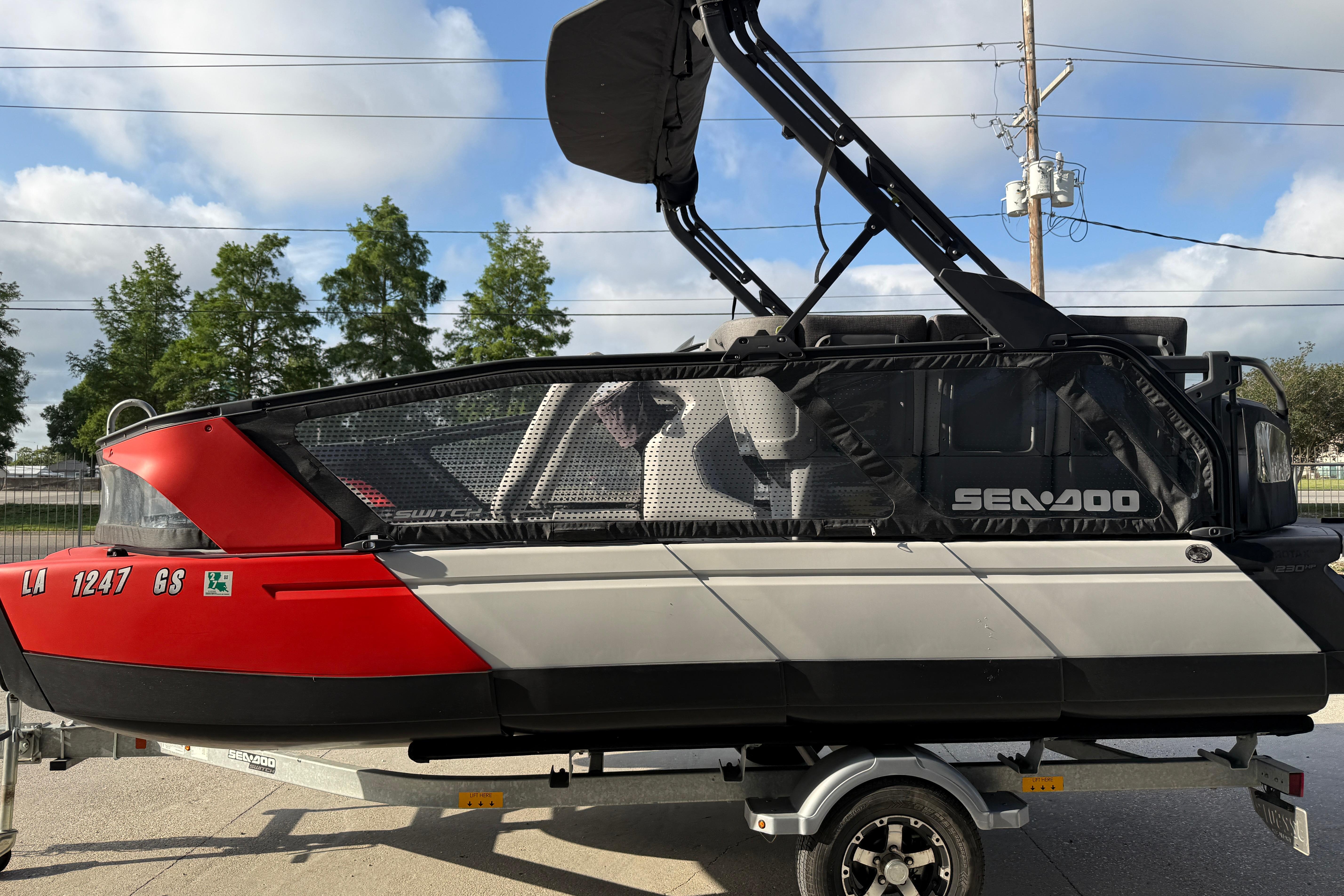 2023 Sea-Doo Switch Sport 18 on trailer, red and gray design, parked outdoors.