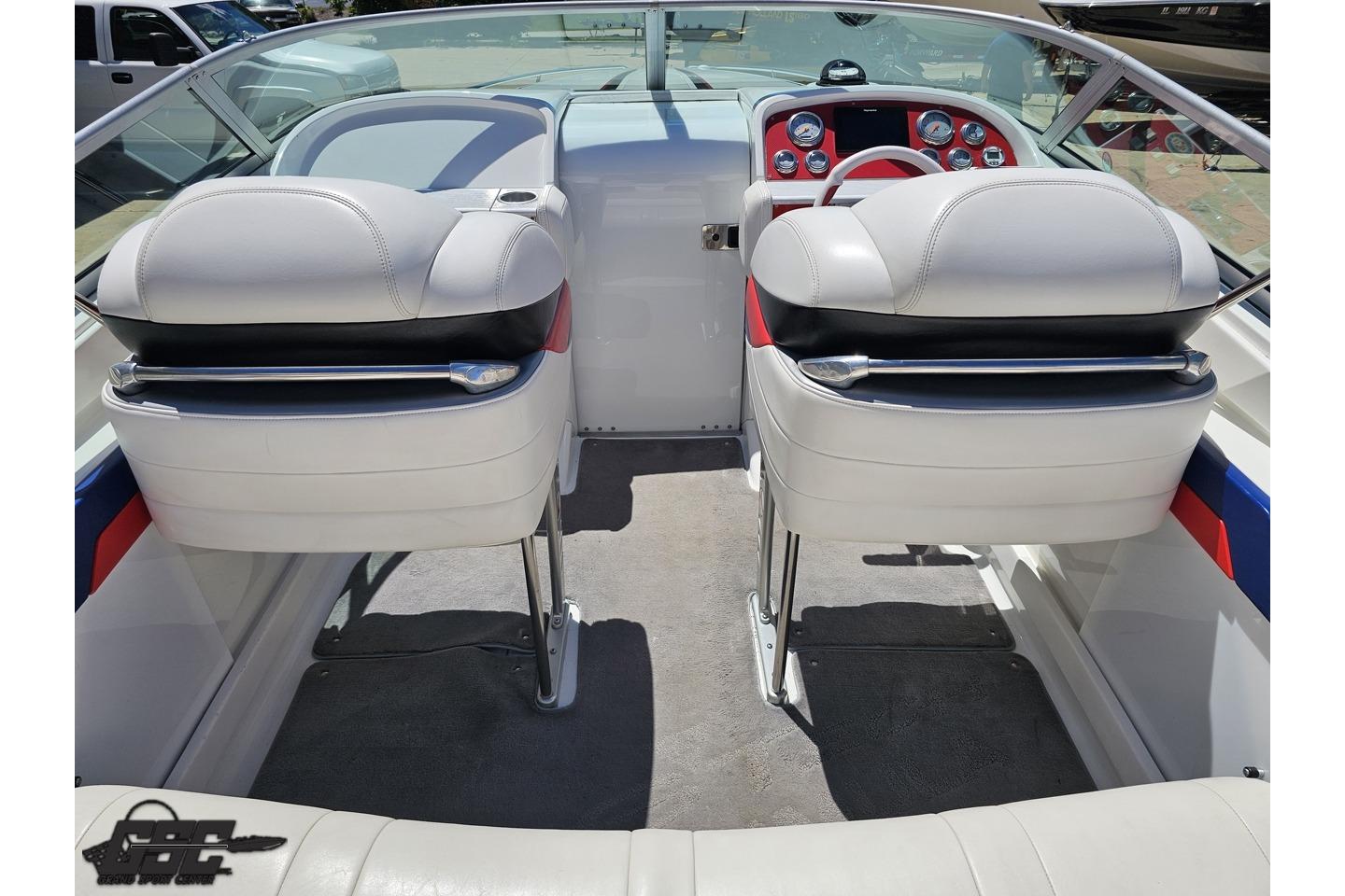 Interior of a 2005 Formula 271 FASTech boat with white seating and red dashboard accents.