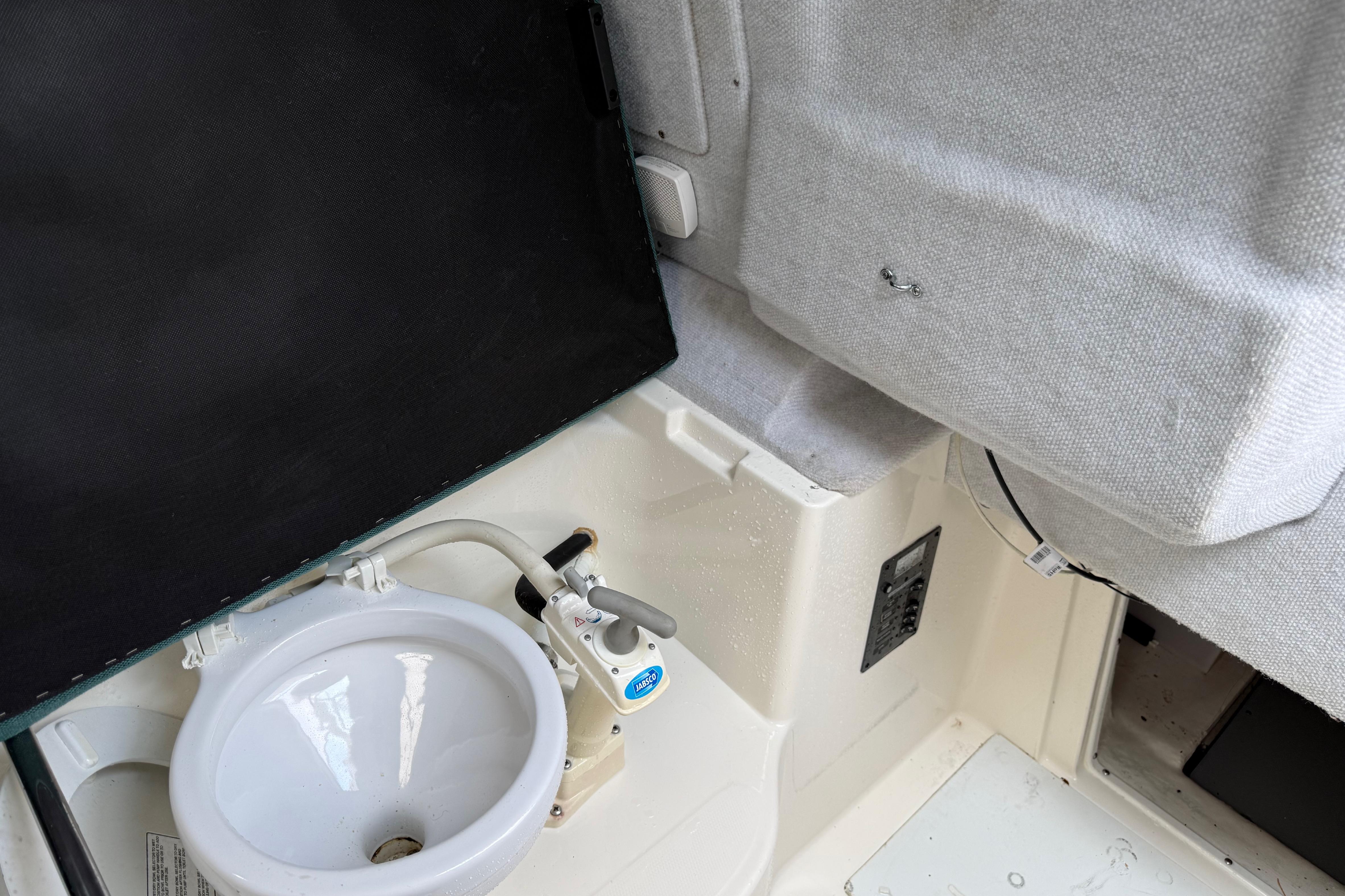 Interior of 2006 Trophy 2502 Walkaround boat with sink and seating area.