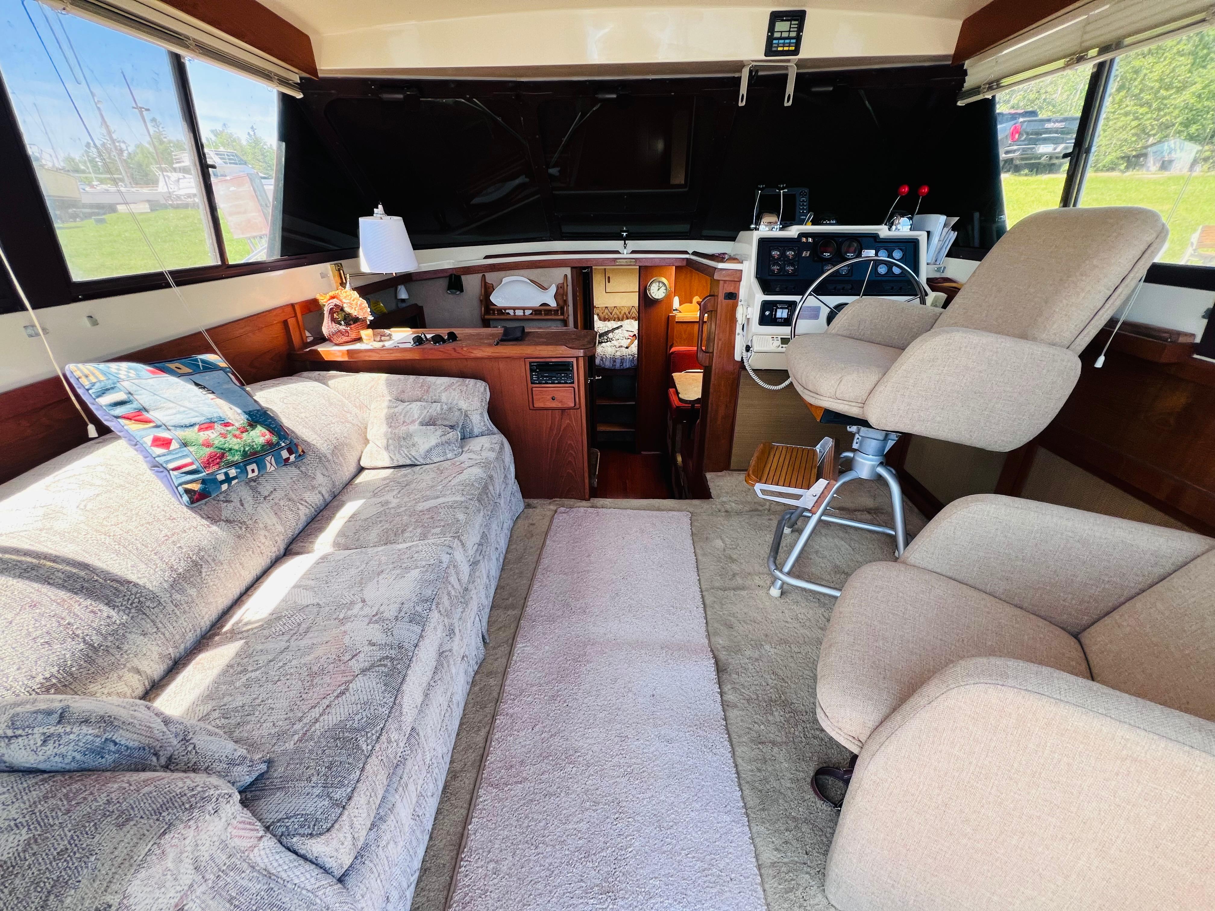 Interior of a 1982 Trojan F32 boat with cozy seating and helm station.