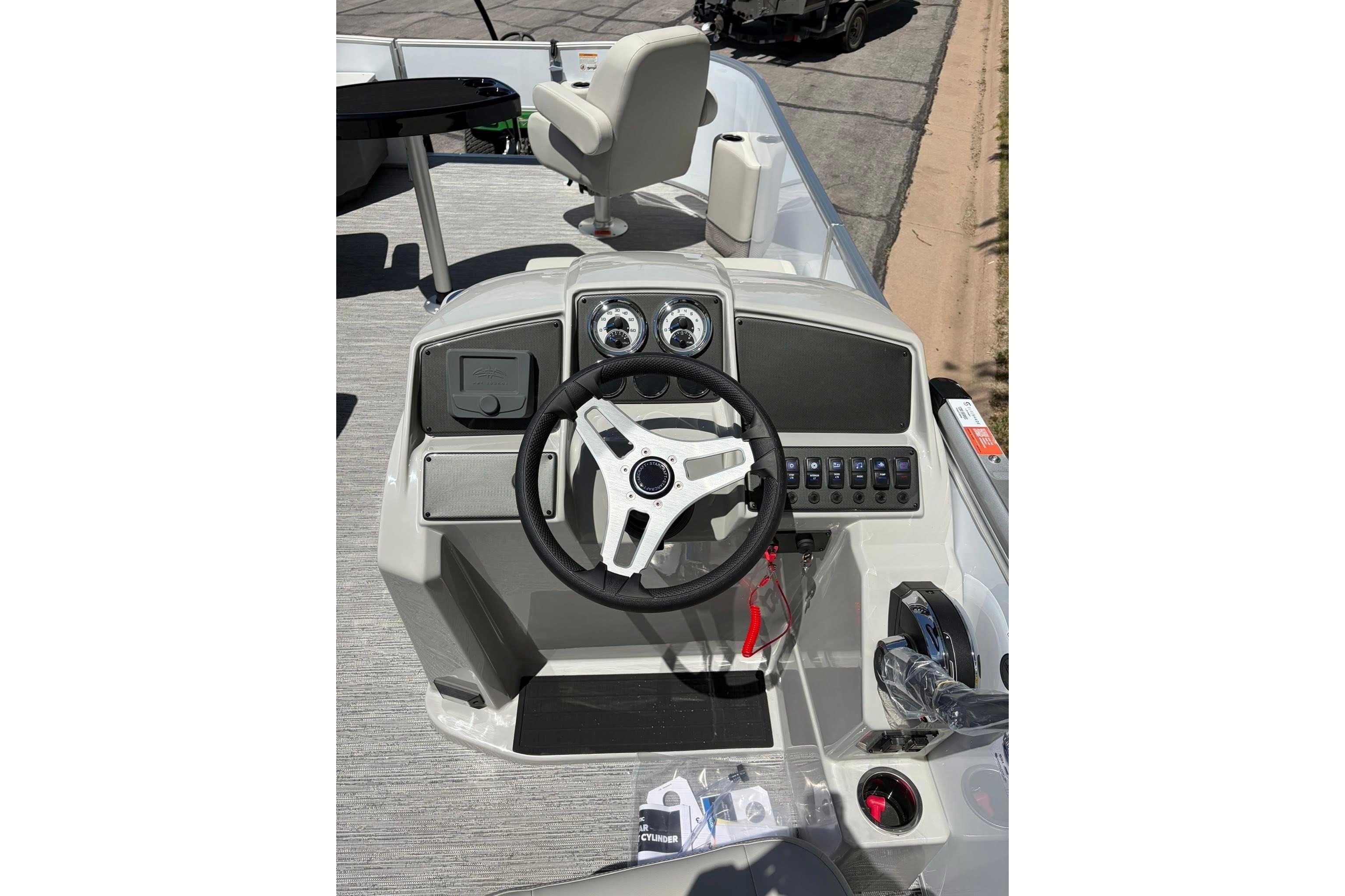 Steering console of 2026 Starcraft EX 22 FD4 boat with modern controls and gauges.