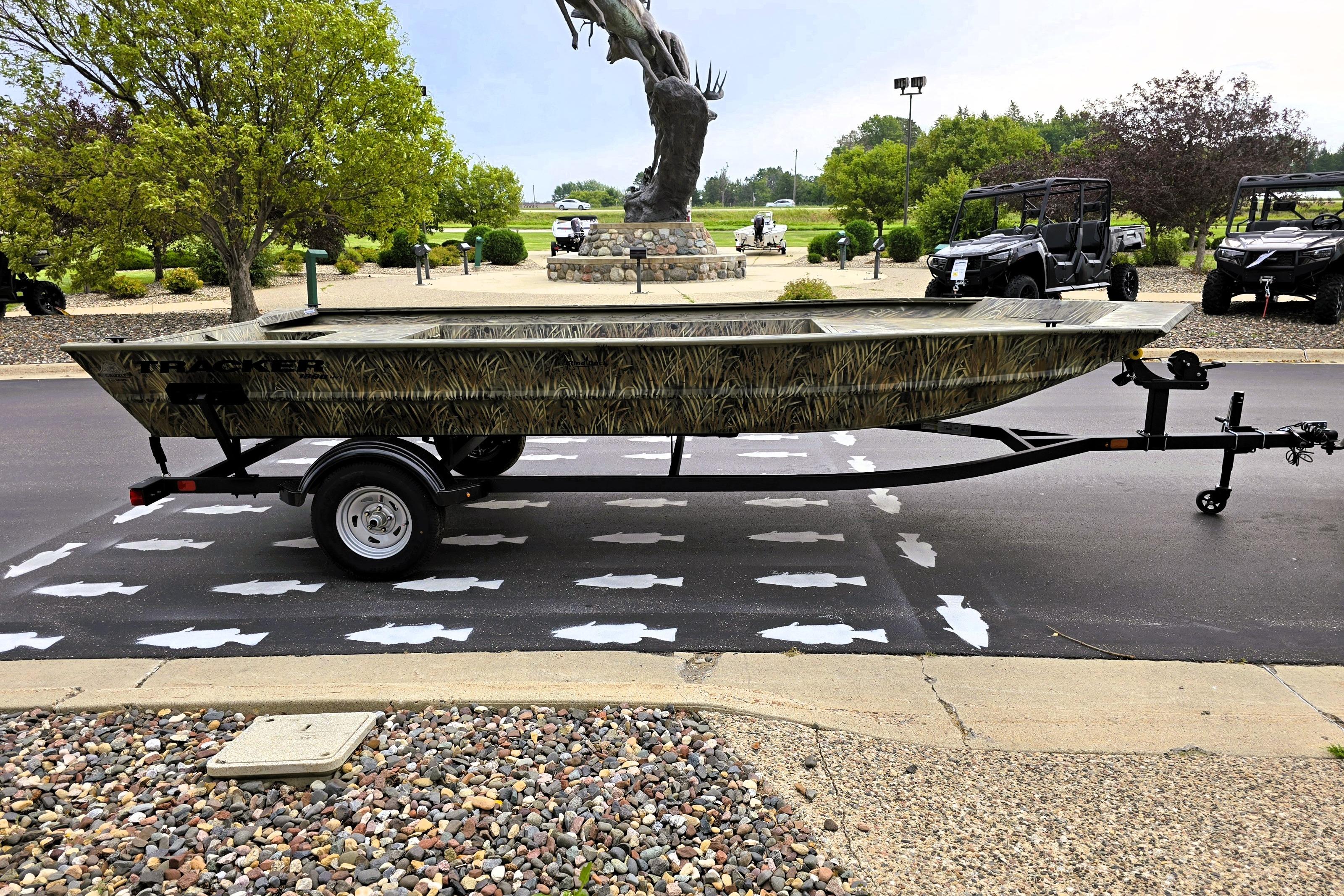 2026 Tracker GRIZZLY 1860 Utility boat on trailer, parked outdoors.