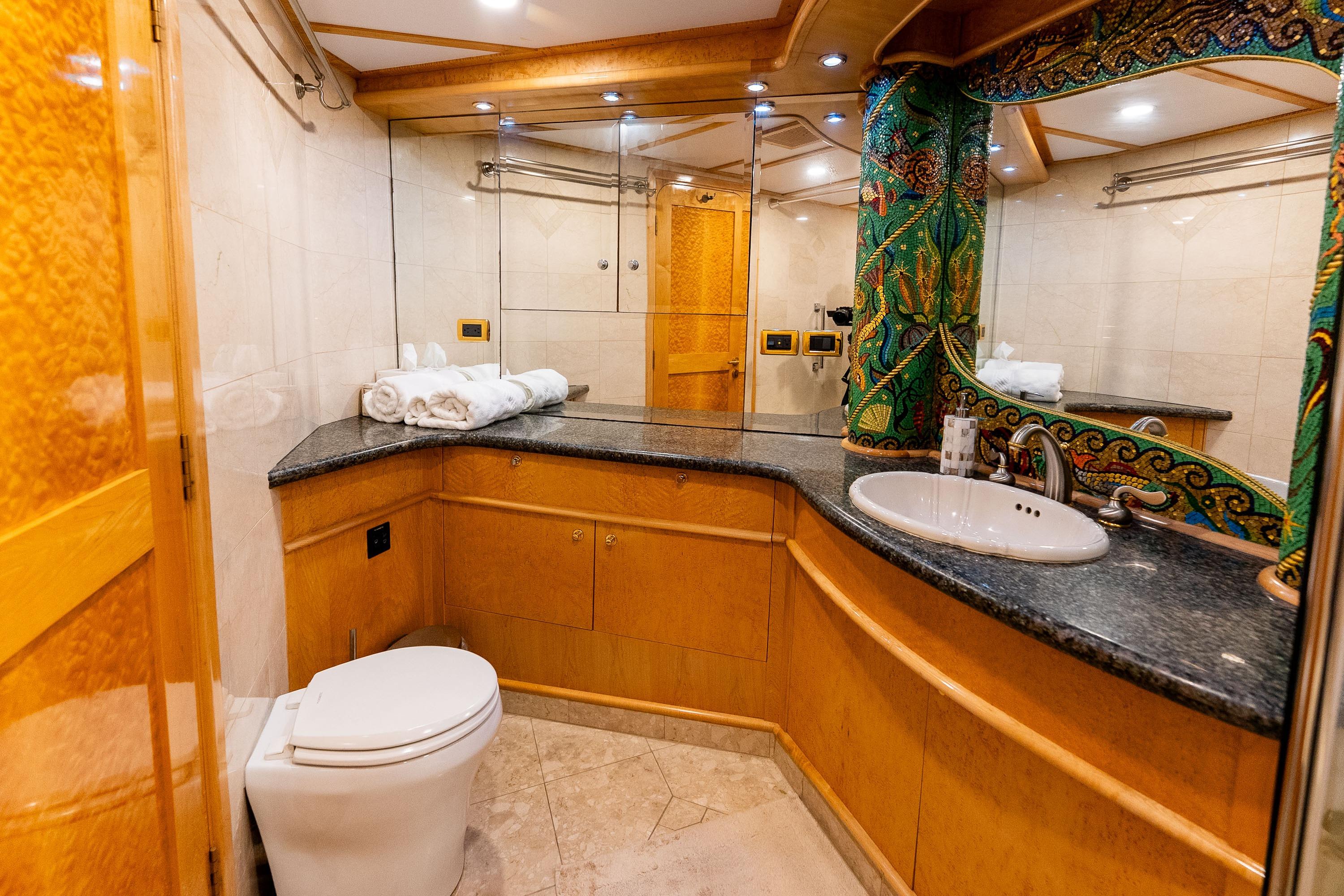 Luxurious bathroom on 1985 Delta Marine Expedition Yacht with elegant wood and marble finishes.
