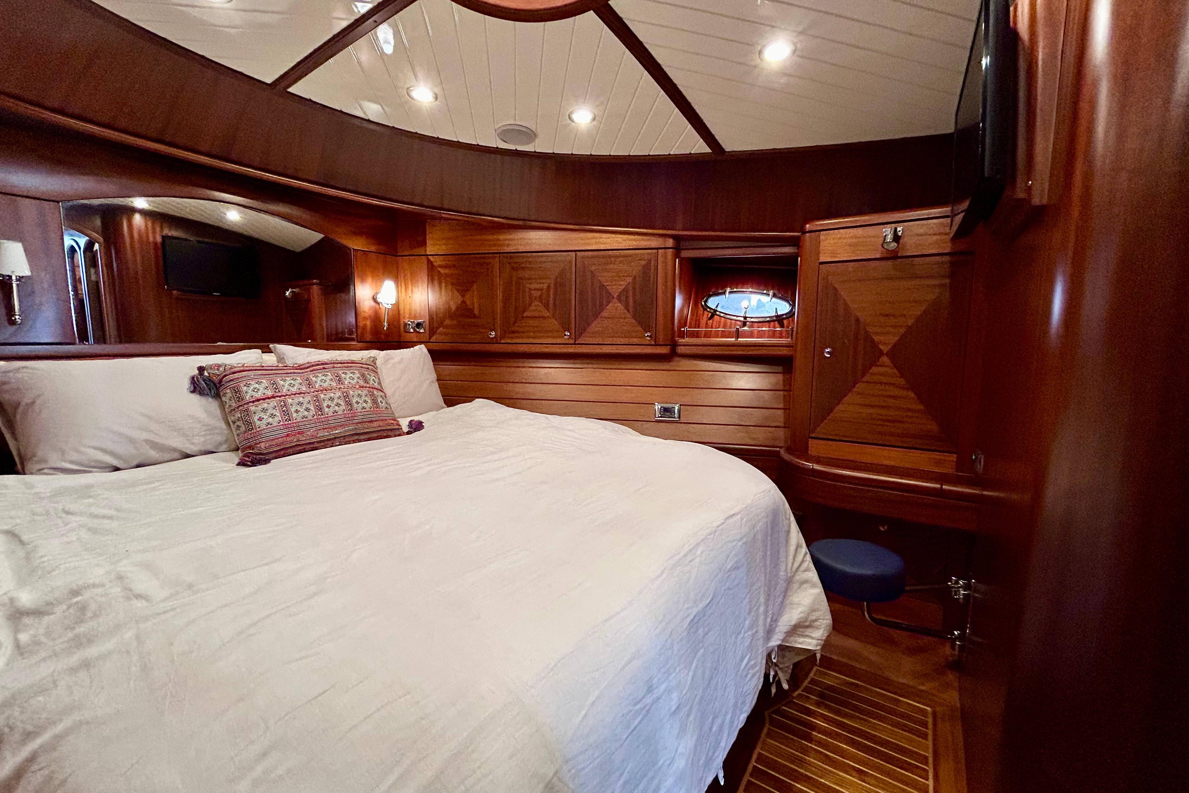 Luxurious 2008 Vicem 44 yacht cabin with elegant wood paneling and cozy bedding.