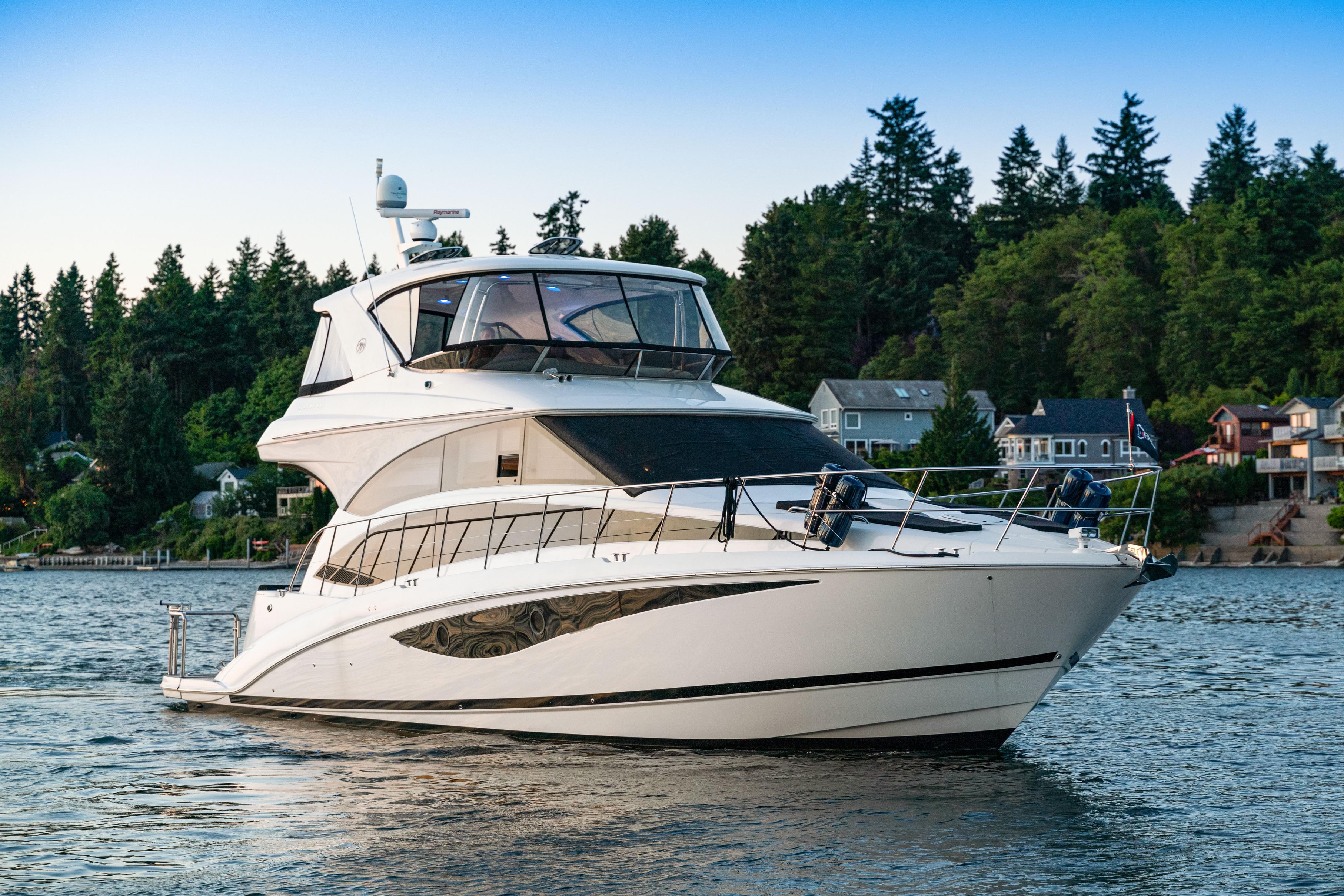 2012 Meridian 541 Sedan yacht on a serene lake with forested shoreline.