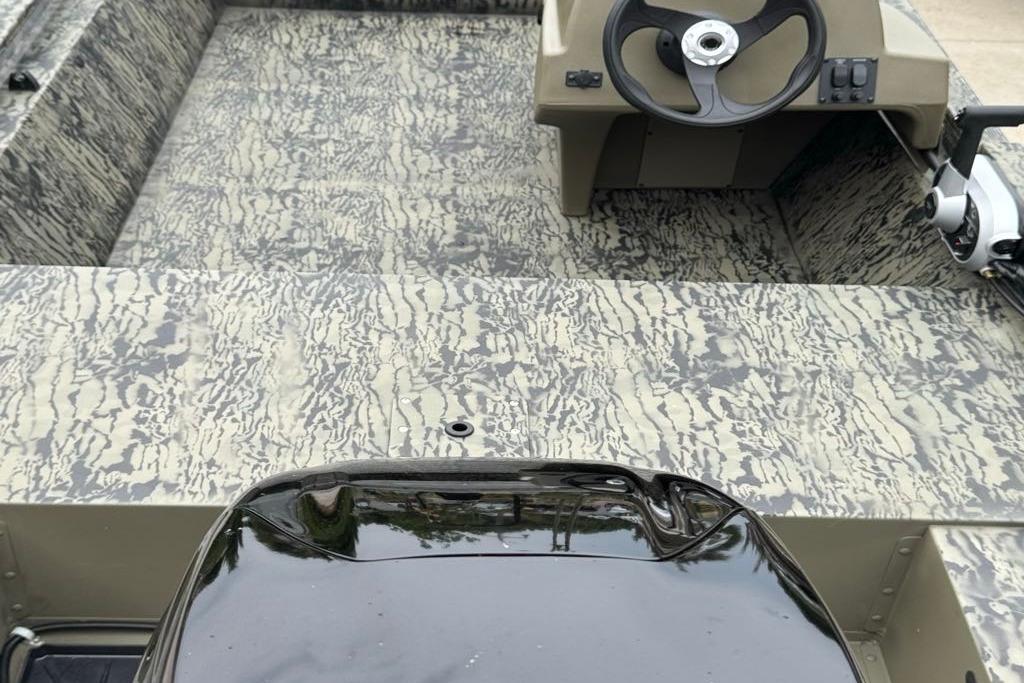 2026 Tracker Grizzly 1648 SC boat interior with camouflage pattern and steering console.