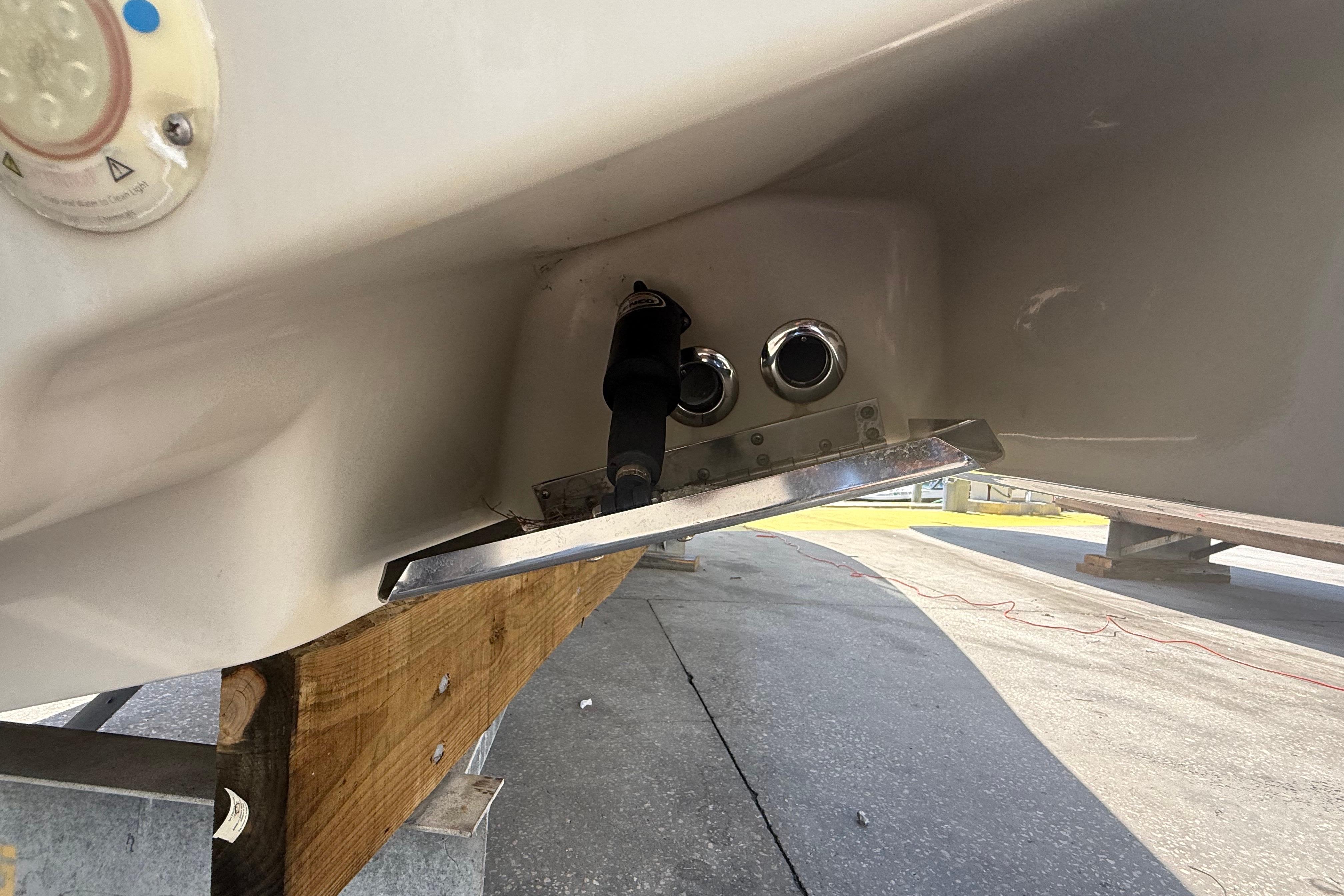 2019 Key West Billistic 281 Center Console boat hull detail with fittings and trim tab.