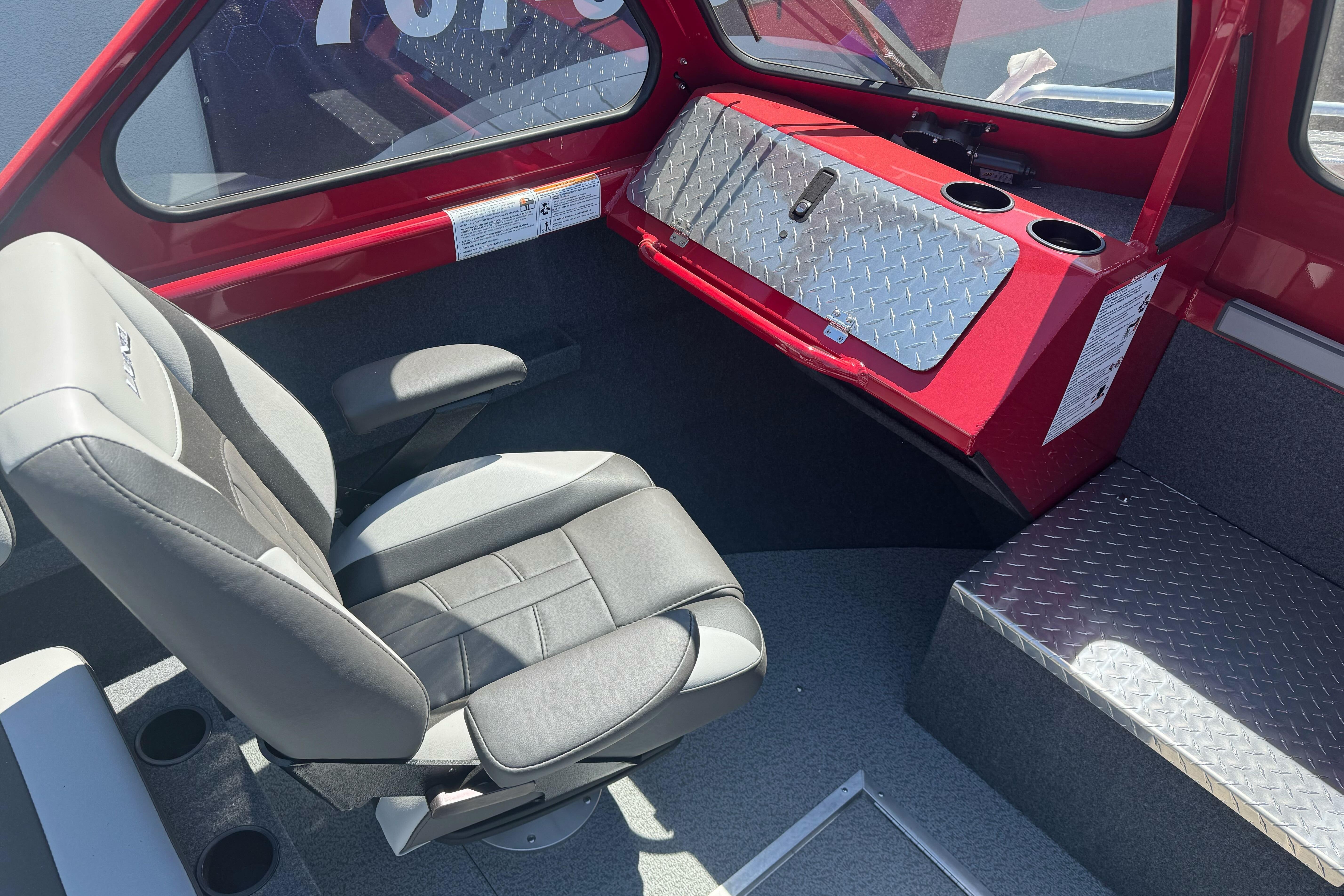 Interior of 2026 Lund 210 Heavy Gauge boat with modern seating and diamond plate accents.