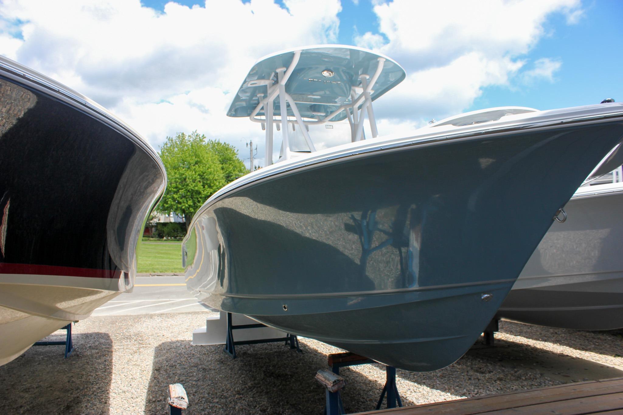 2027 Sea Hunt Ultra 234 boat displayed outdoors under a blue sky.