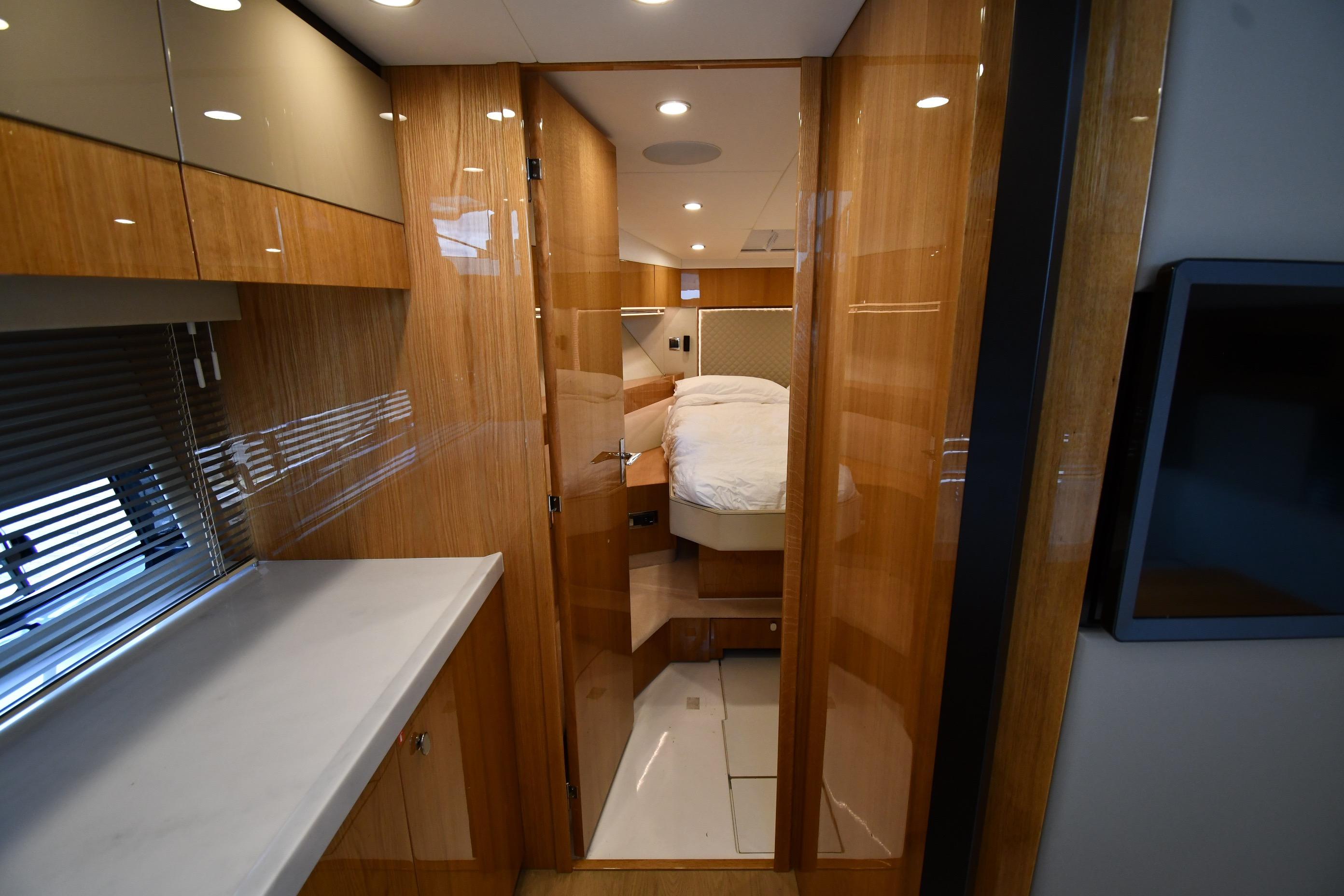 Luxurious interior of 2024 Fairline G50 Targa yacht, featuring sleek wood finishes and modern design.