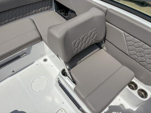 2023 Four Winns H1 boat interior with gray cushioned seating and cup holders.