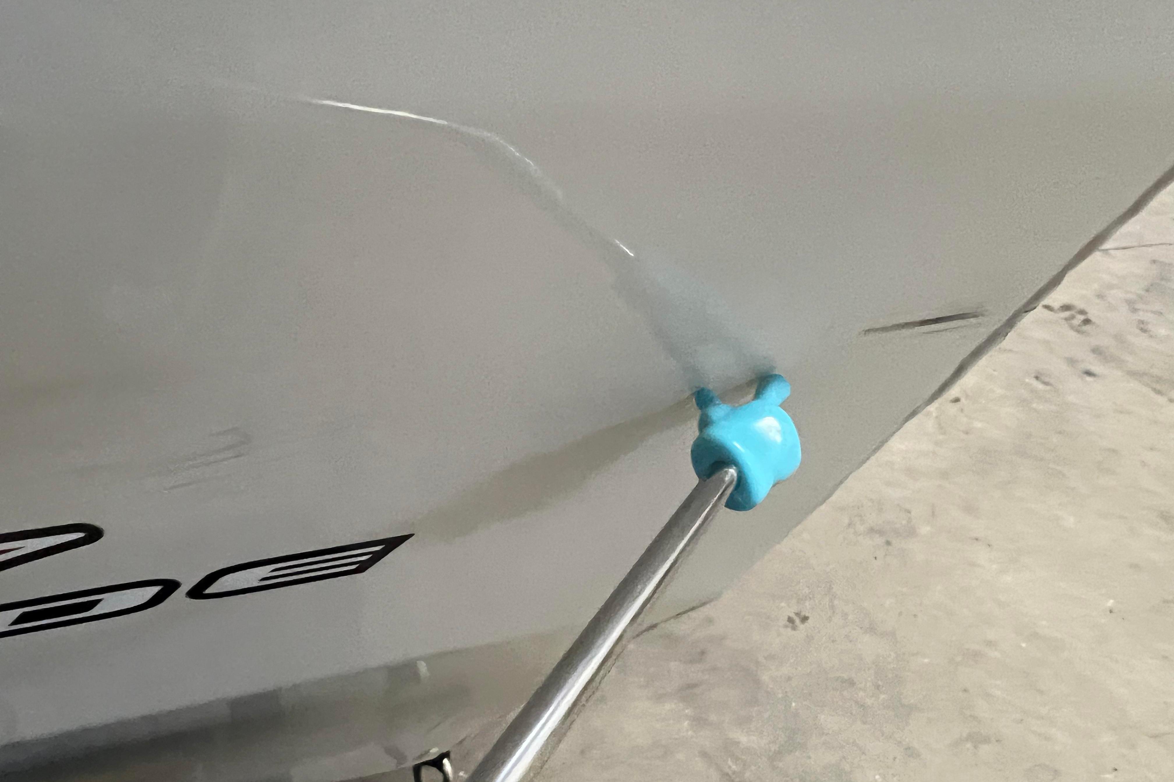 2022 Tracker Pro Guide V-16 WT boat with a blue plug on the hull.