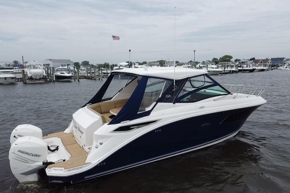 2021 Sea Ray Sundancer 320 Outboard boat docked in a marina.