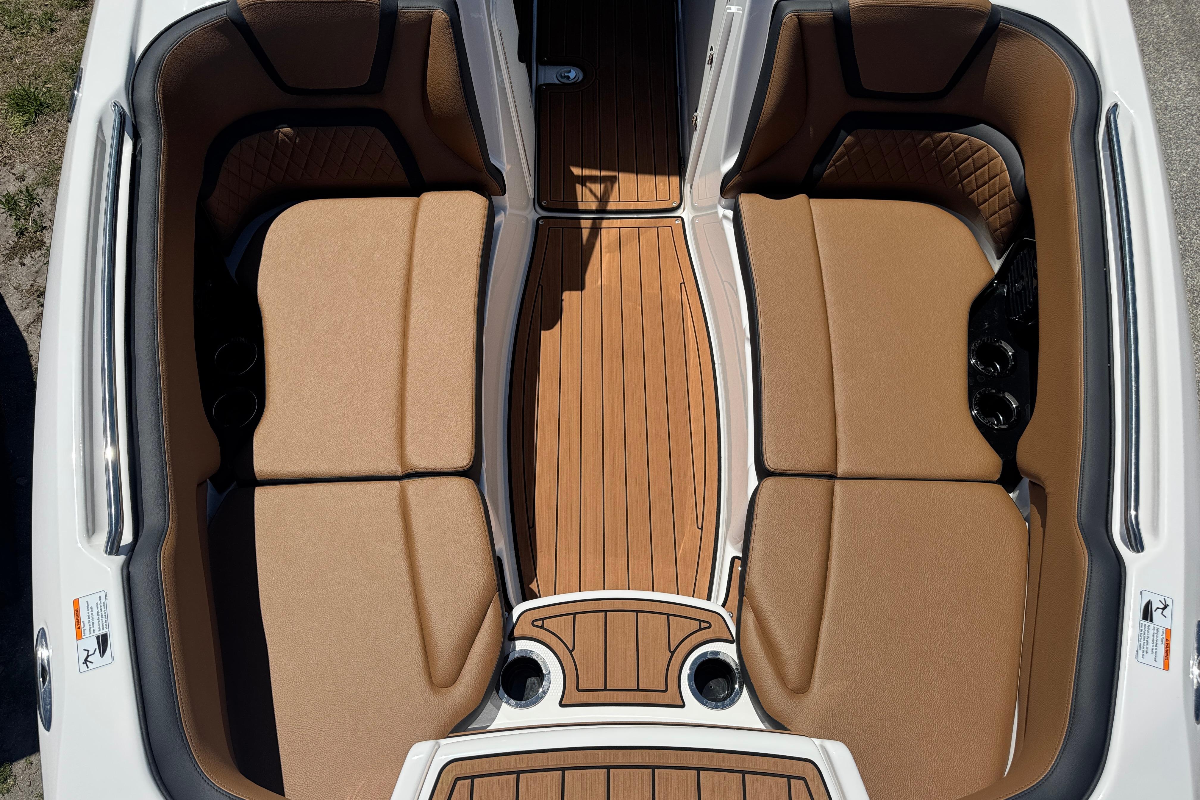 2026 Yamaha Boats 252SD interior with tan seating and wood-style flooring.