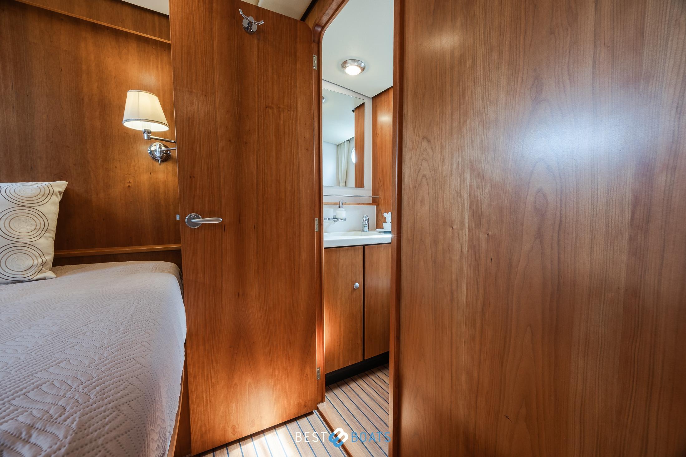 Interior of 2010 Linssen Grand Sturdy 43.9 AC yacht, featuring cozy cabin and bathroom.