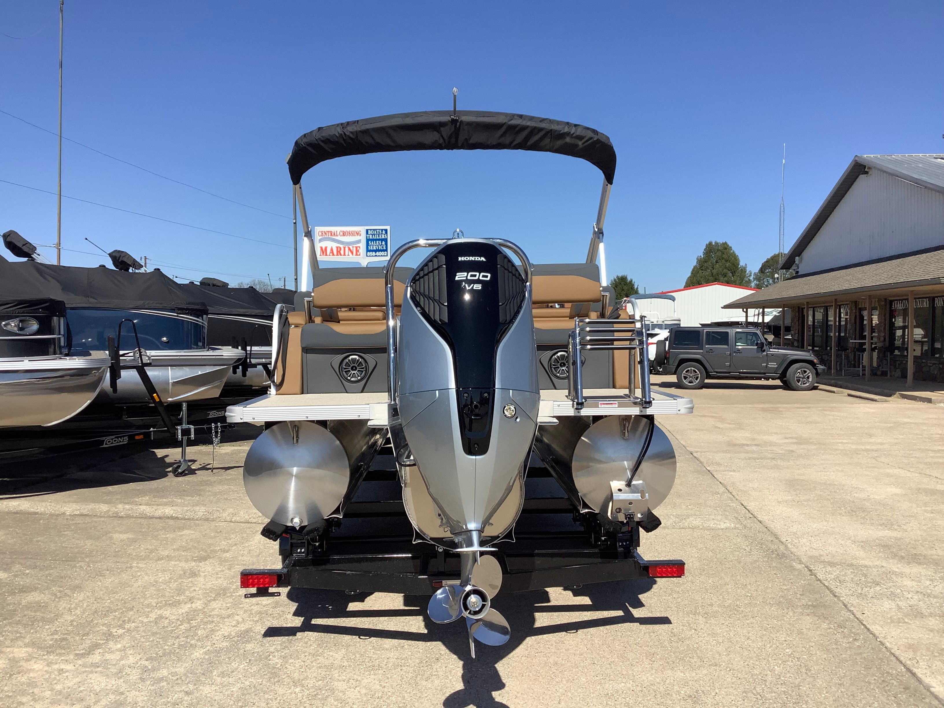 2026 Tahoe 2385 LTZ Quad Lounger boat with outboard motor.