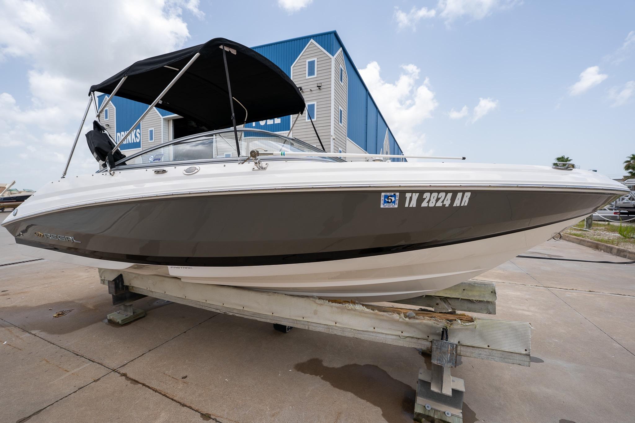 2008 Regal 2000 Bowrider boat on display, featuring sleek design and black canopy.
