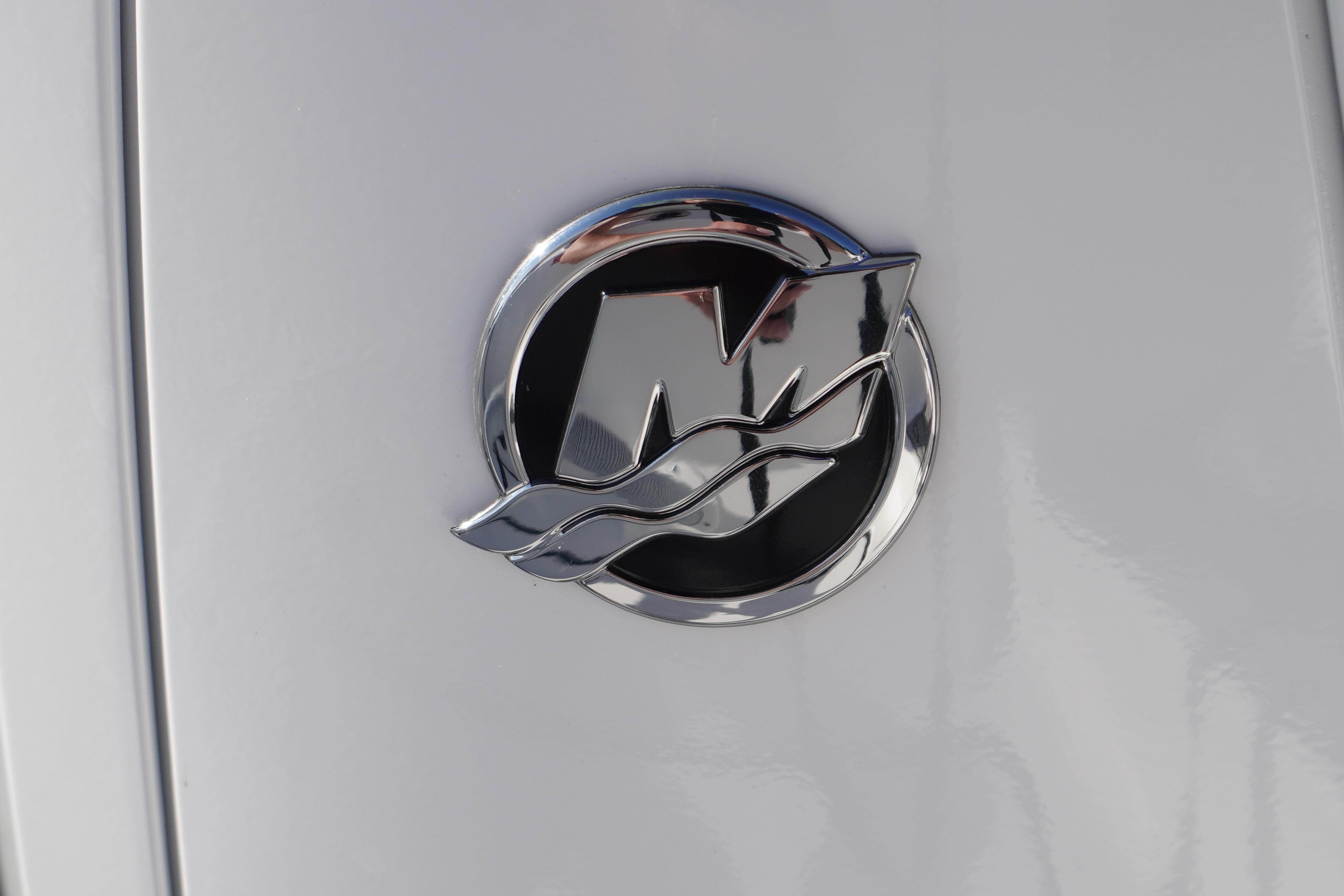 Chrome emblem on 2026 Tidewater 272 LXF boat, featuring sleek design elements.