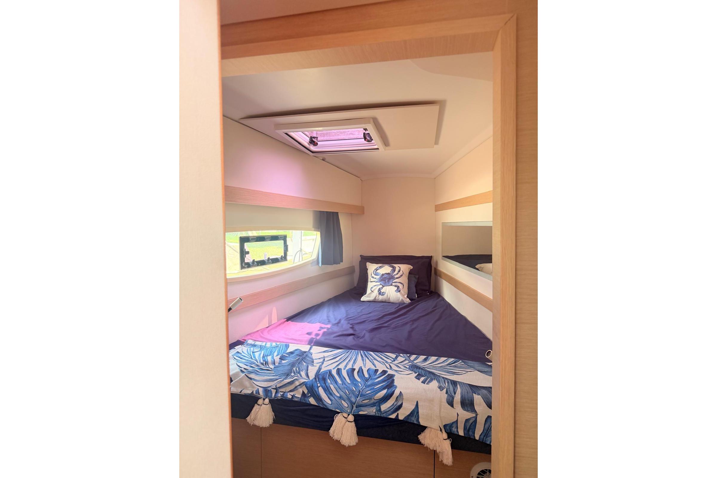 Cozy cabin interior of 2018 Fountaine Pajot Lucia 40 catamaran with nautical decor.