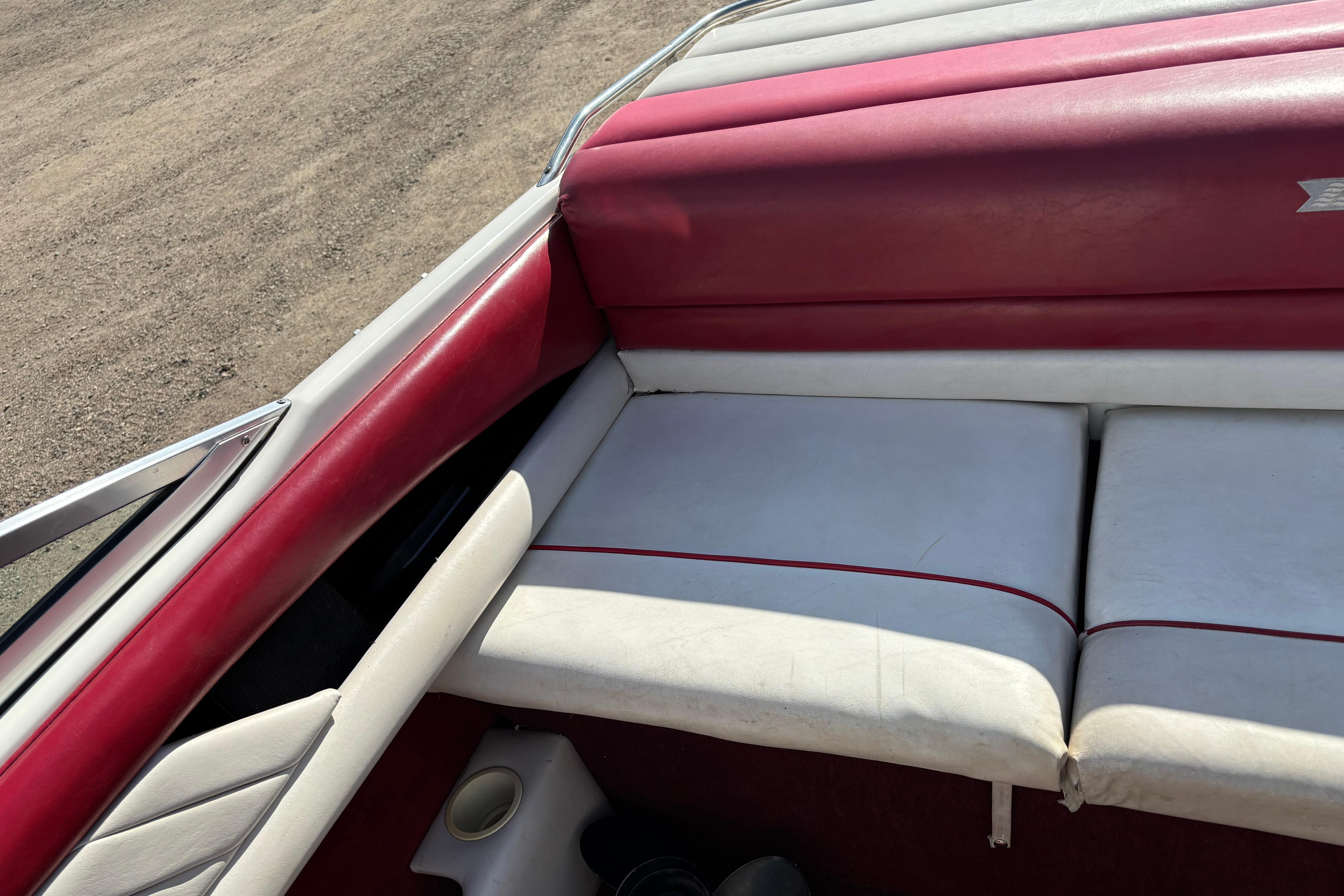 Interior of a 1993 Larson SEi 200 Cuddy I/O boat with red and white seating.