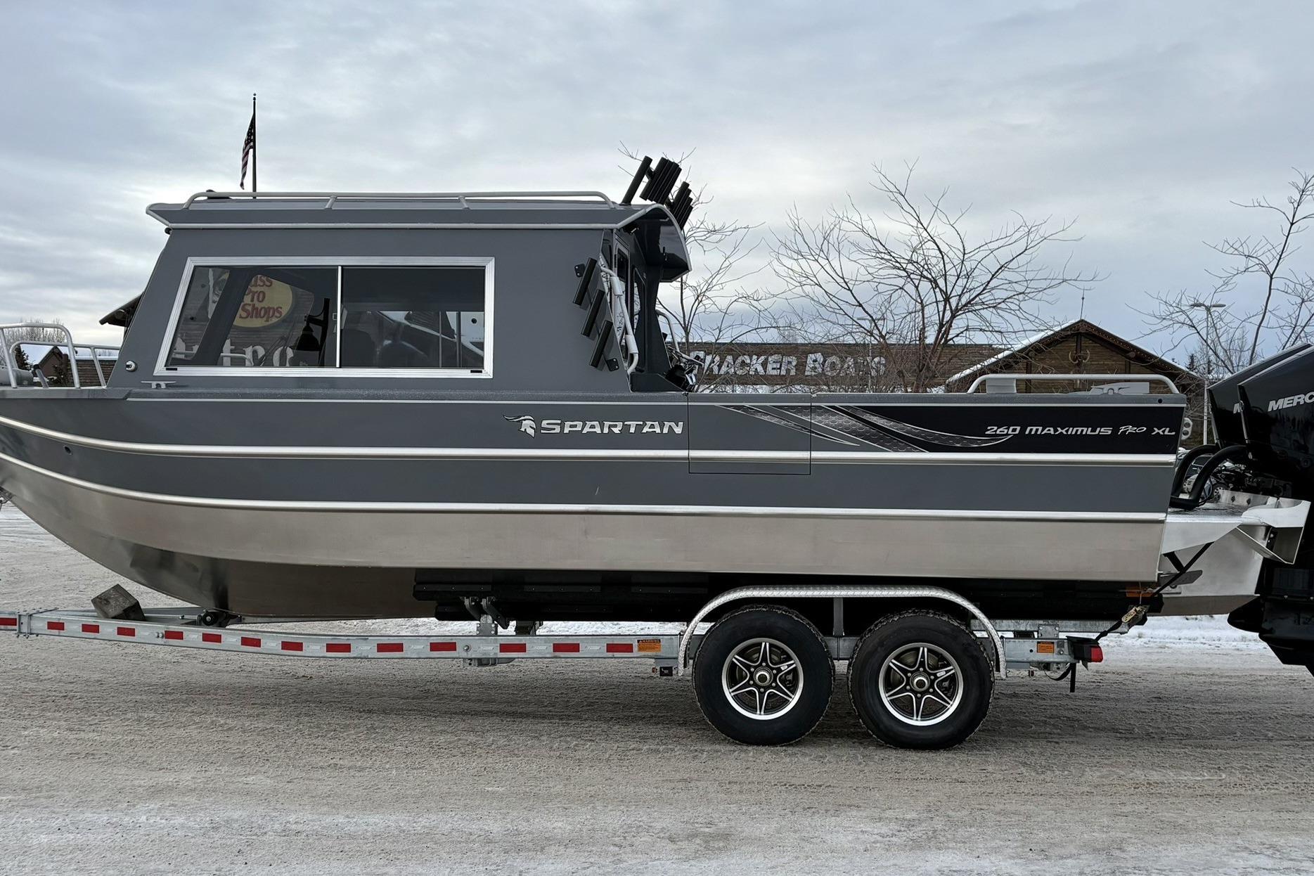 2024 Spartan 26 Maximus Pro XL boat on trailer, side view.