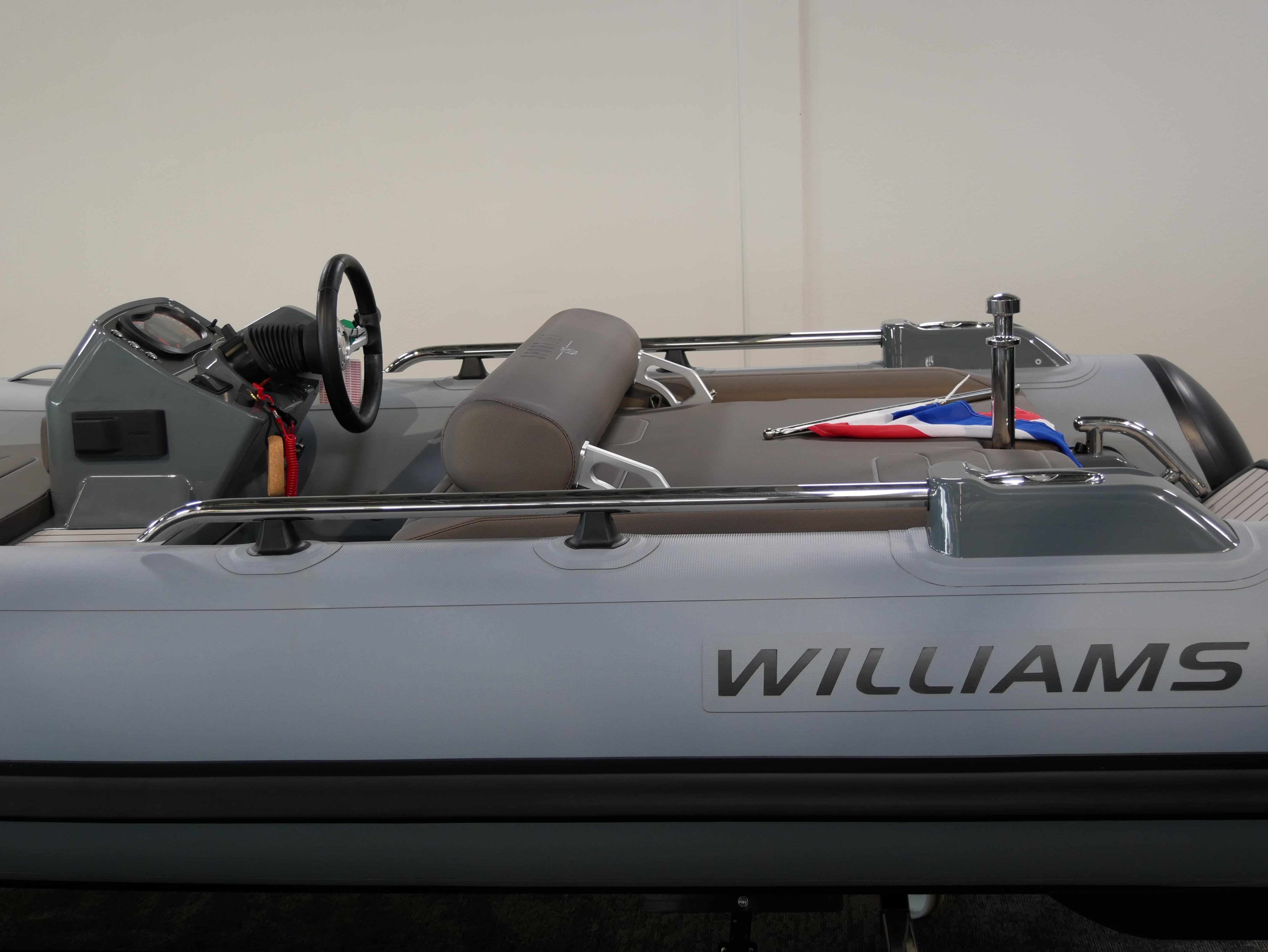 2025 Williams Jet Tenders SportJet 435, sleek design, gray interior, steering wheel, and flag detail.