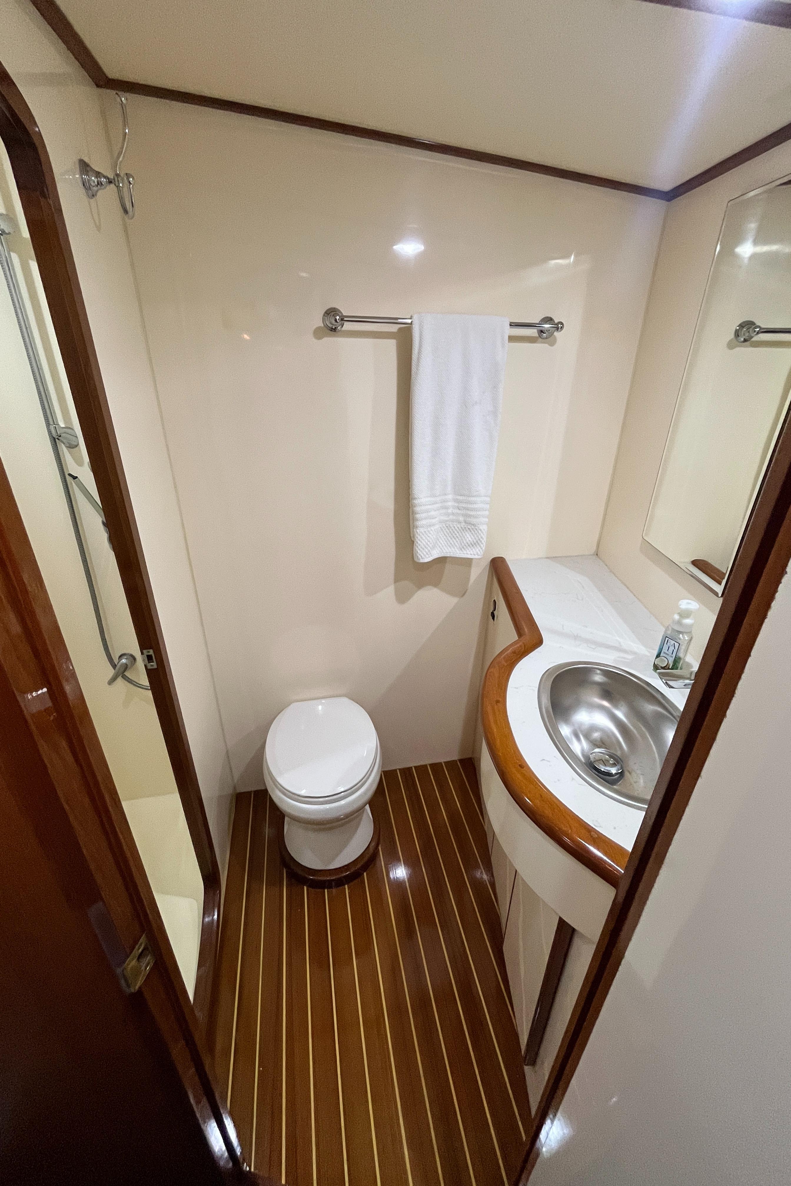 1999 Mikelson Long-Range Luxury Sportfisher bathroom with wood flooring, sink, and shower.