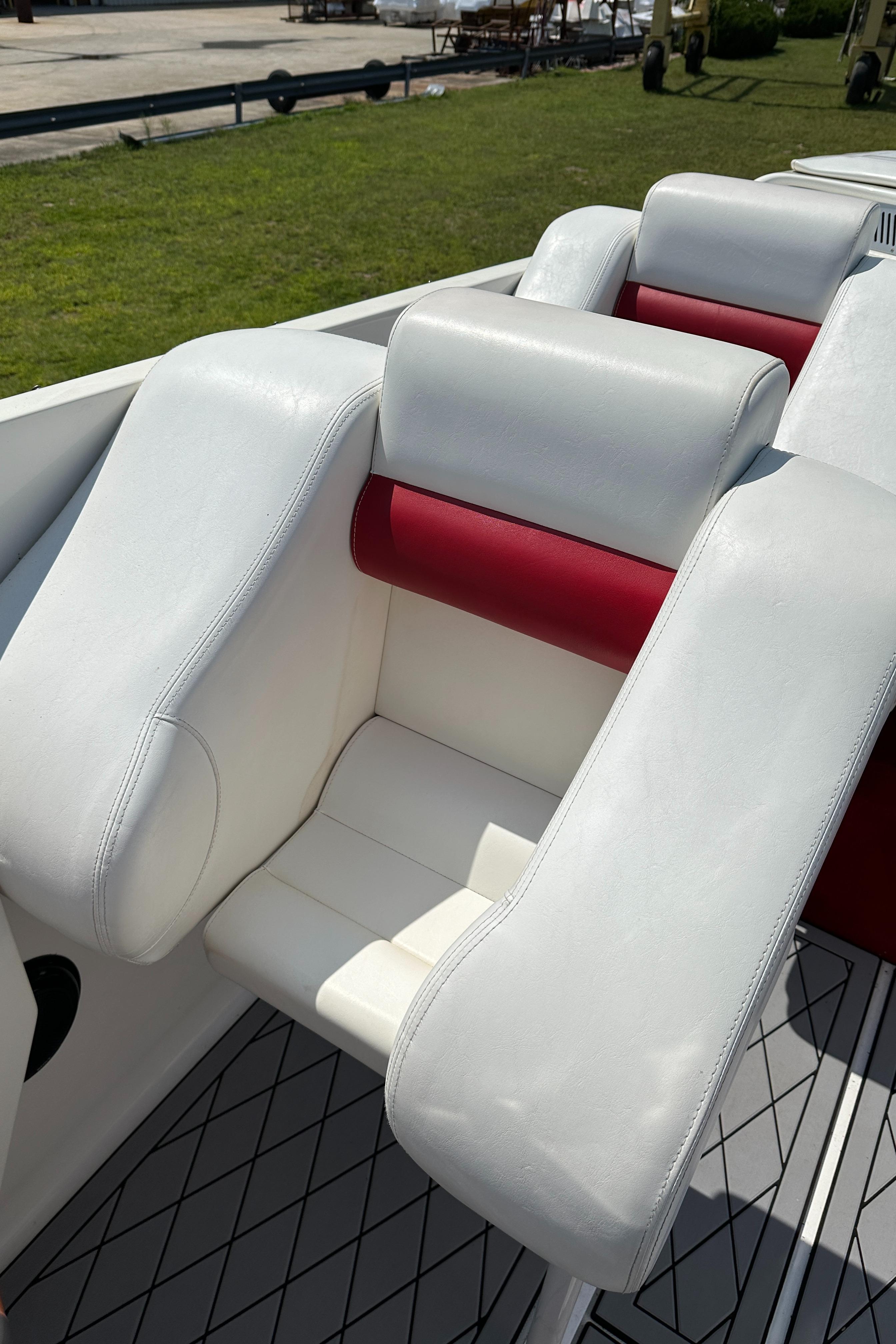 2004 Hustler 388 SLINGSHOT boat interior with white and red seating.
