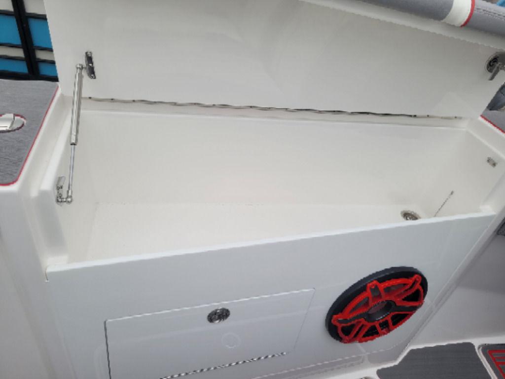 2024 Fountain 38 SCX storage compartment with red-accented speaker detail.