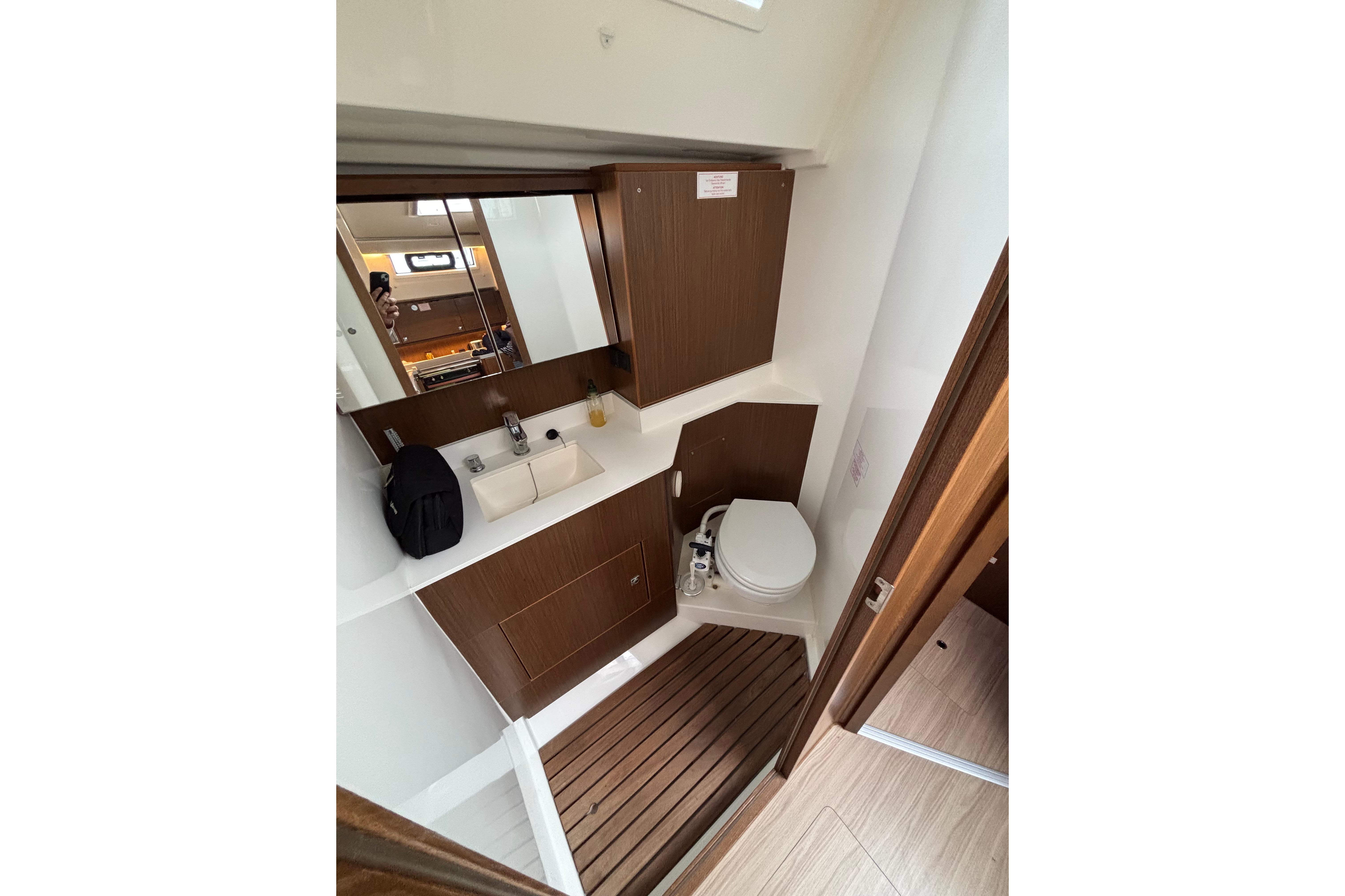 2019 Bavaria C45 yacht bathroom with wooden accents and modern fixtures.