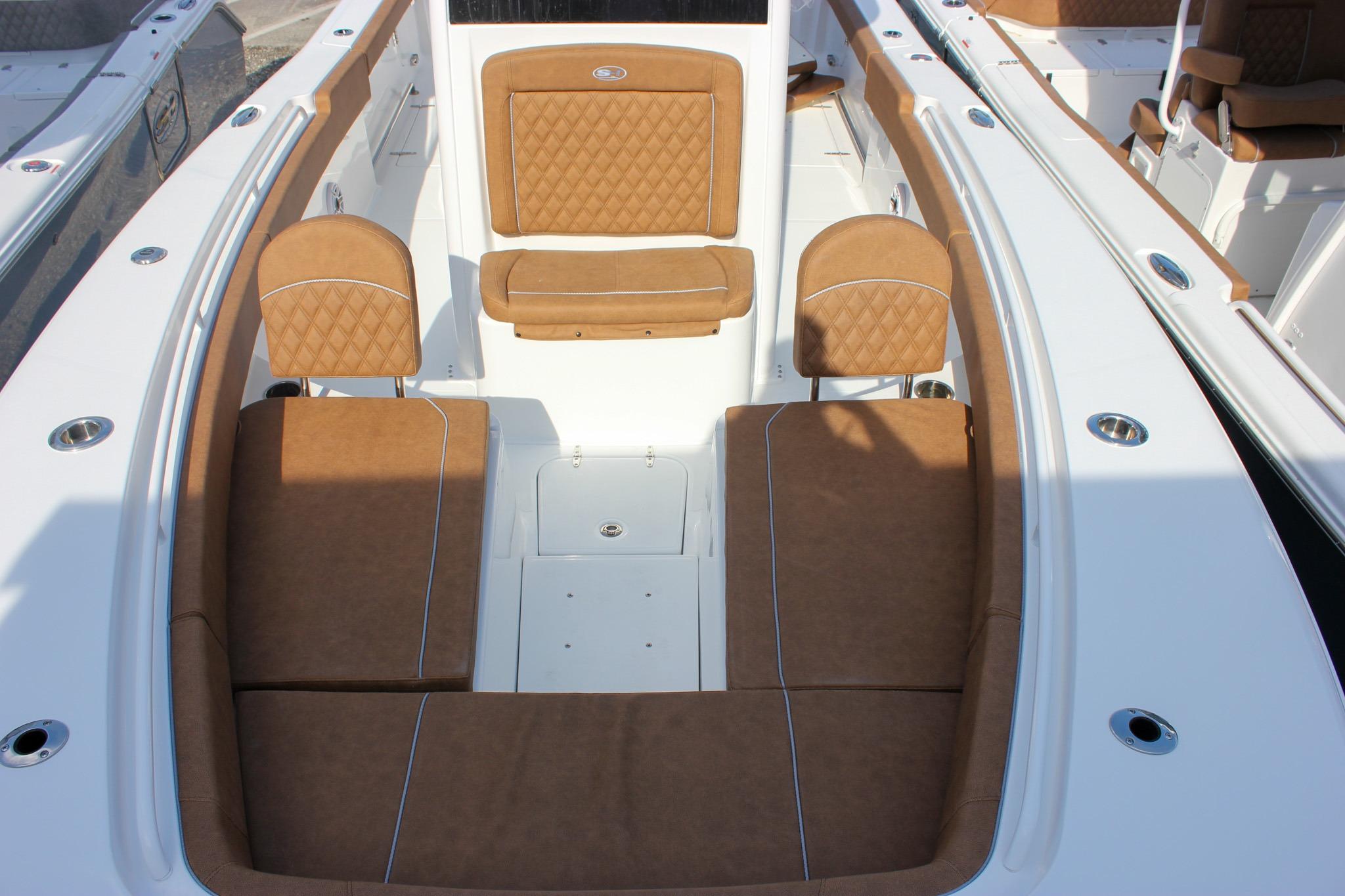 2027 Sea Hunt Ultra 275 SE boat interior with tan cushioned seating and sleek white finish.