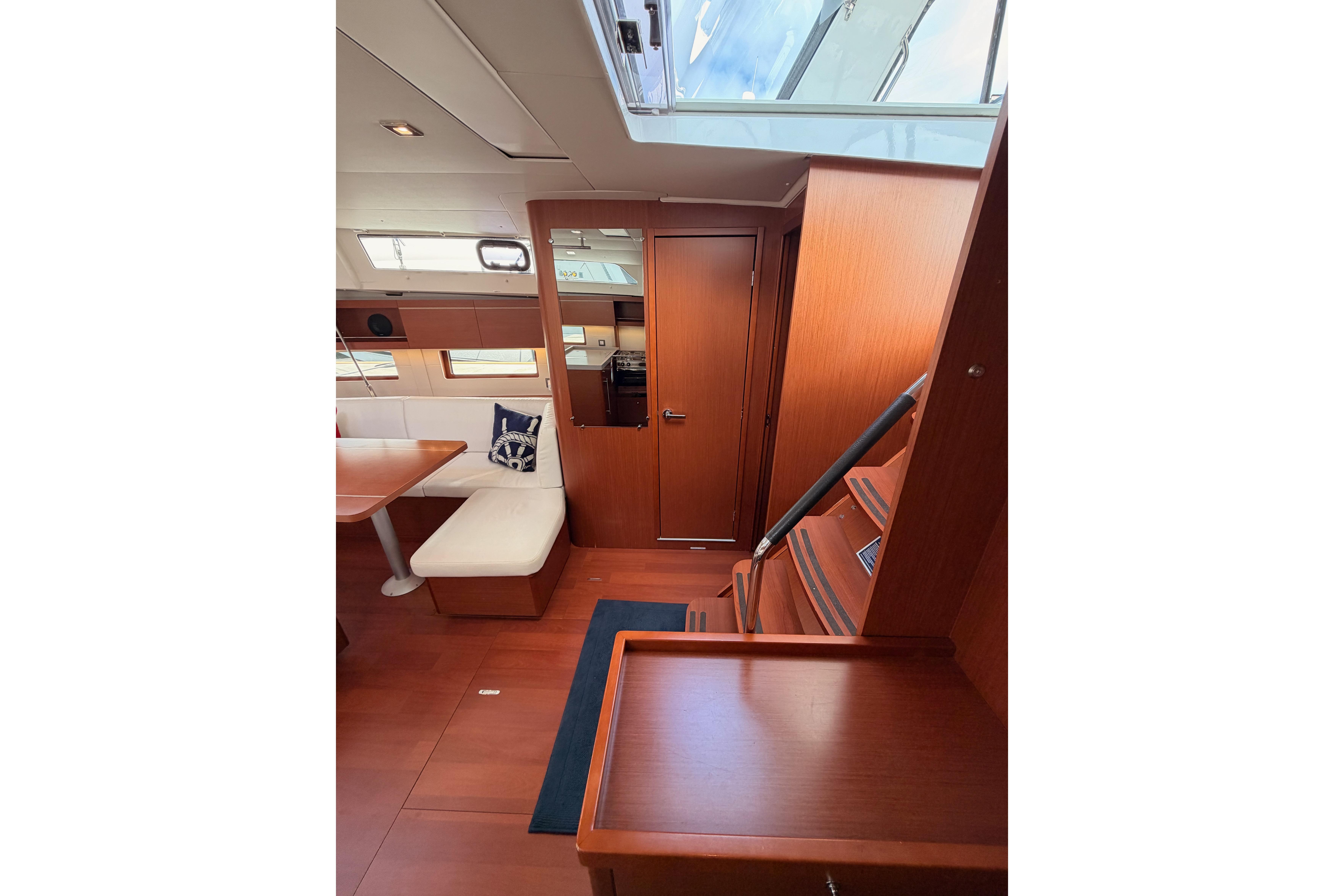 Interior of 2020 Beneteau Oceanis 46.1 yacht with wooden finish and seating area.