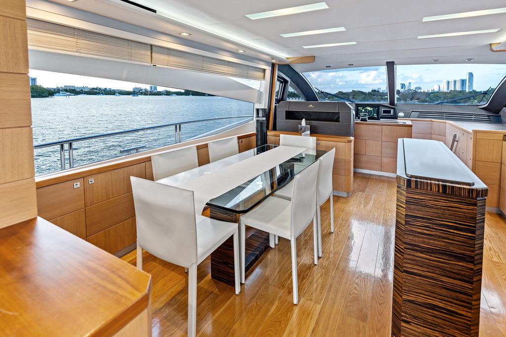 Luxurious interior of 2013 Astondoa 72 GLX yacht with modern dining area and scenic water view.