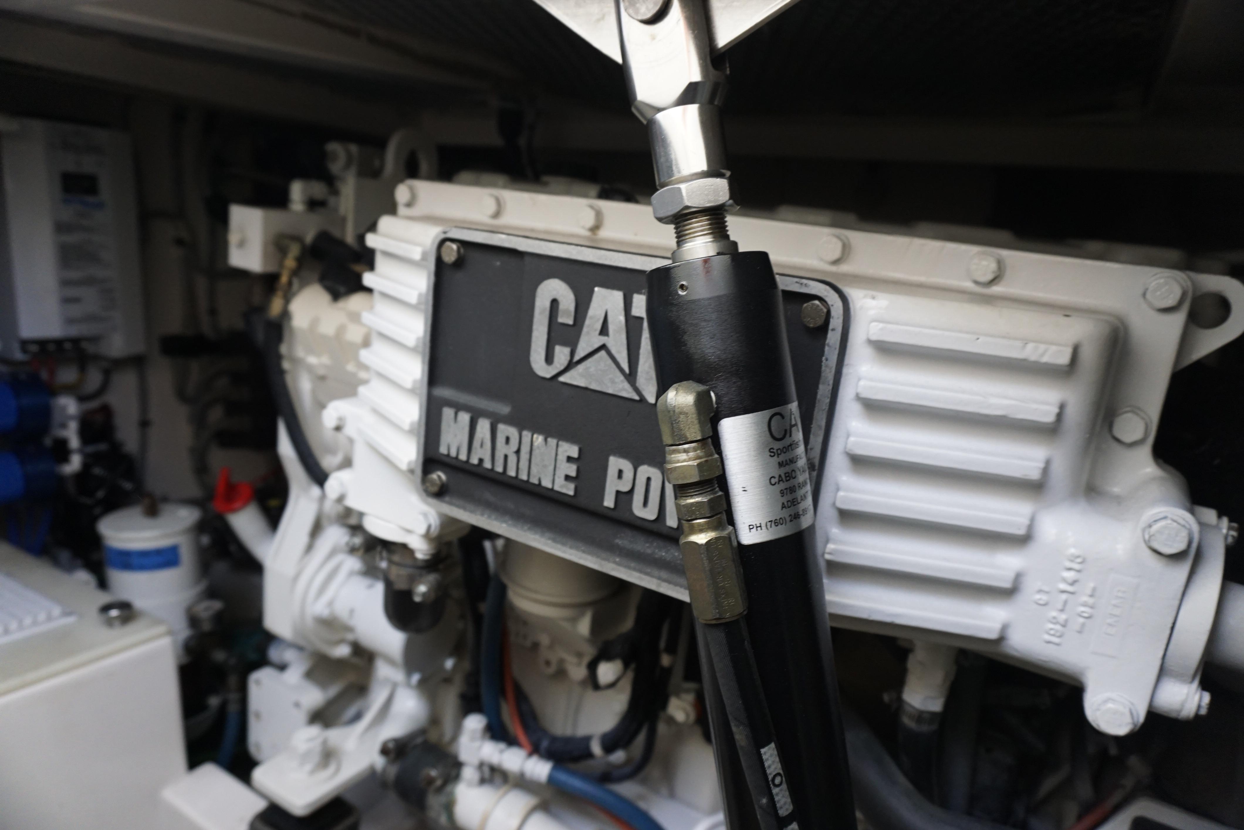 Engine compartment of a 2005 Cabo 35 Express boat, featuring CAT Marine Power components.