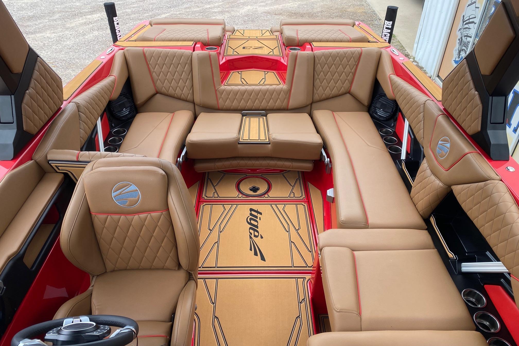 Luxurious interior of 2026 Tigé Z3 boat with tan leather seating and red accents.