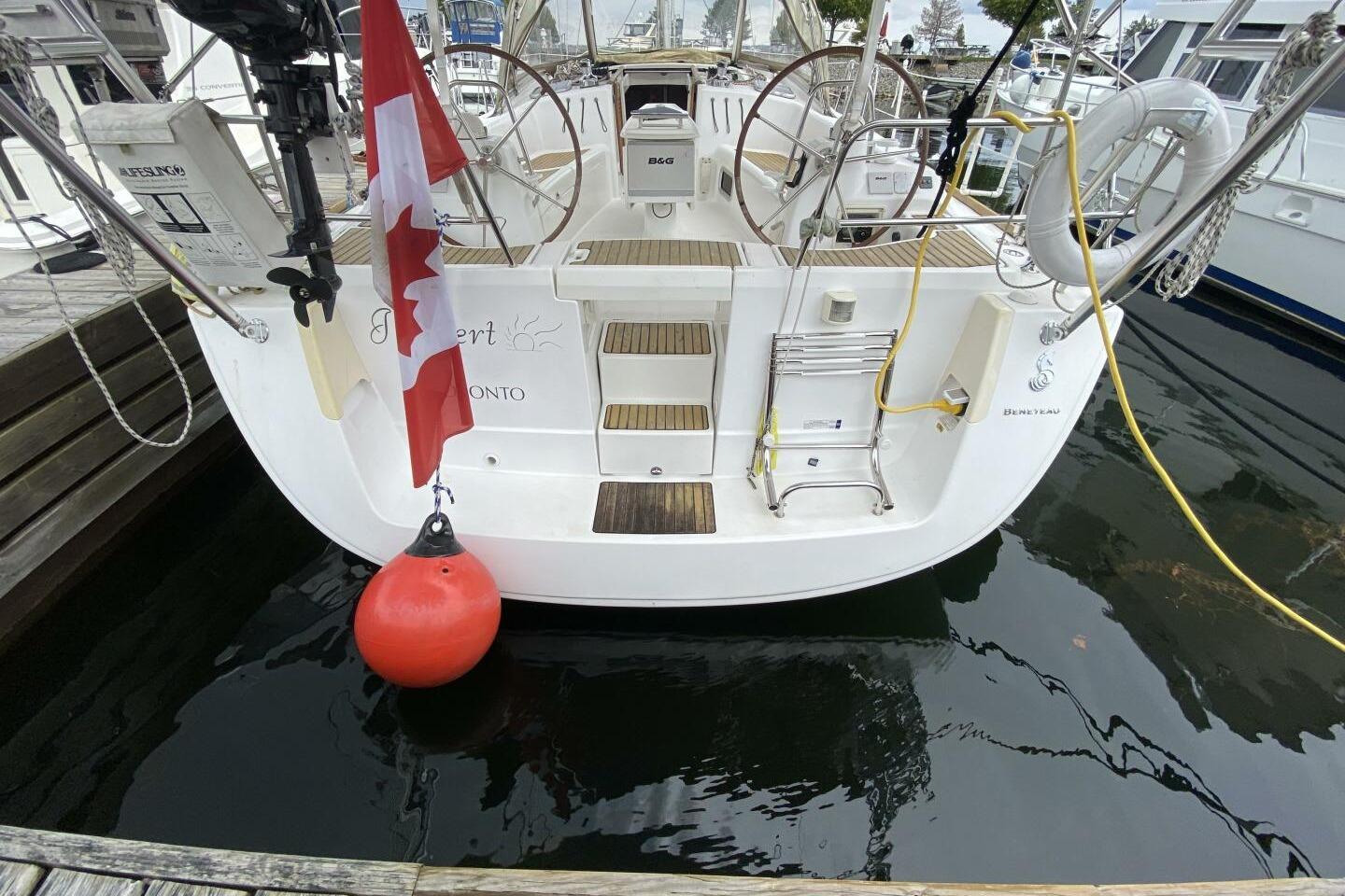 Beneteau 43 sailboat, 2009 model, docked with Canadian flag and safety equipment.