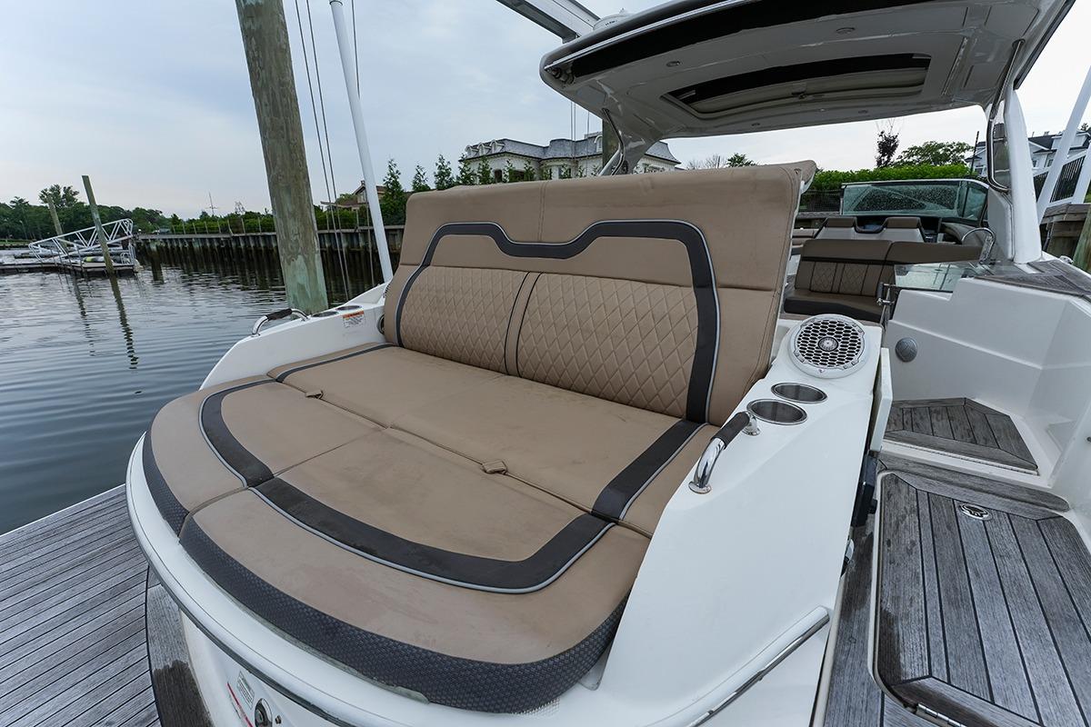 2018 Sea Ray SLX 350 boat with luxurious seating and sleek design at a dock.
