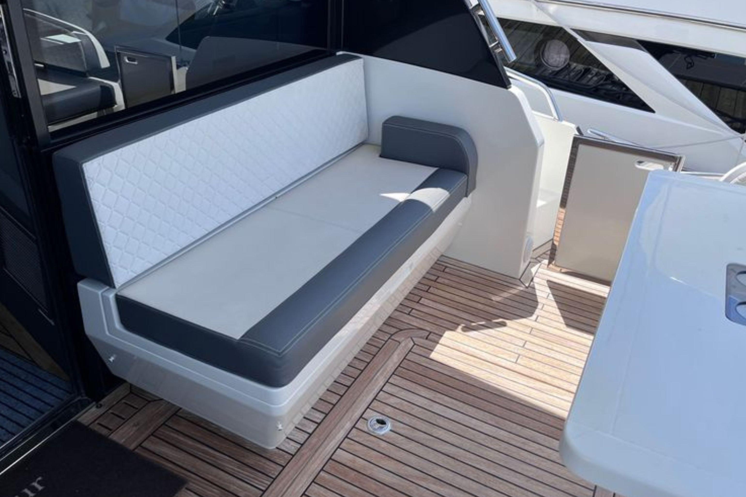 Luxury seating area on 2024 Galeon 425 HTS yacht with elegant wood flooring.