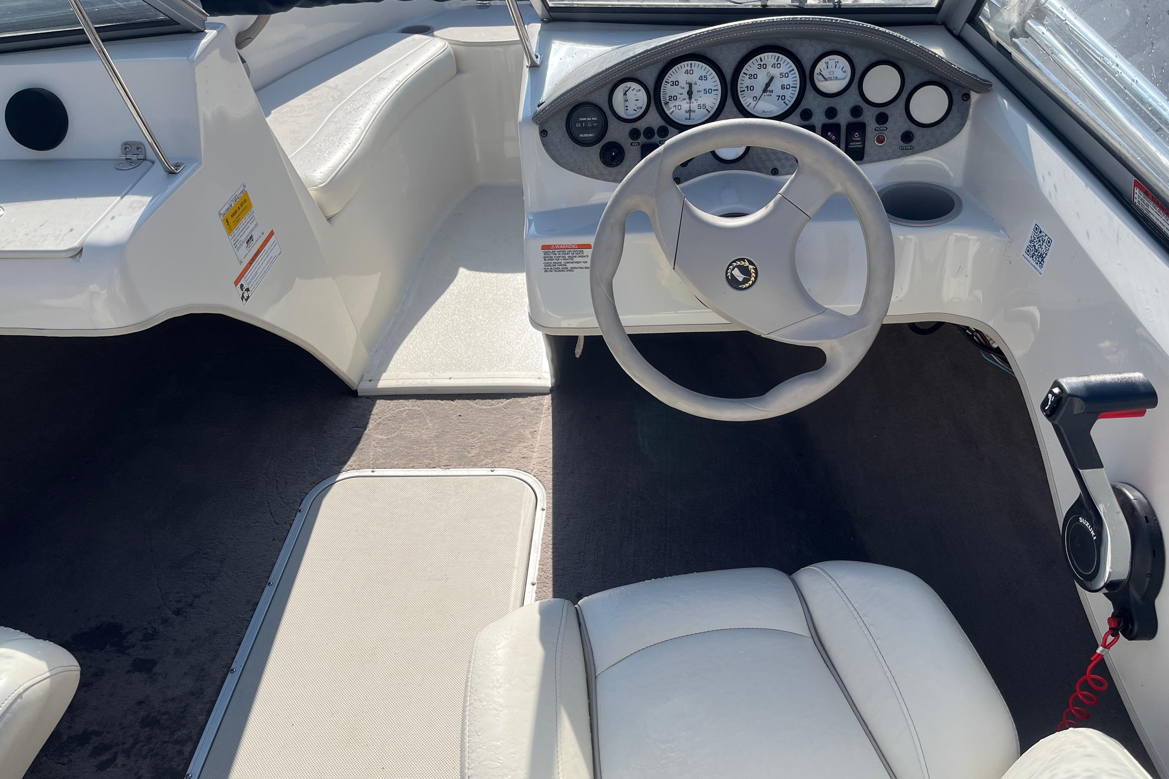 Interior of a 2013 Stingray 191 RX boat featuring steering wheel and dashboard controls.