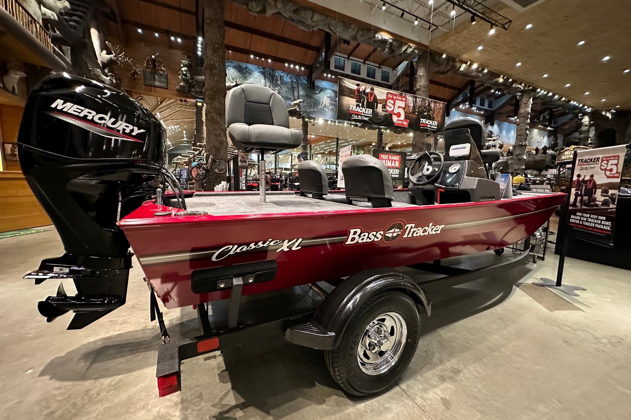 2026 Tracker Bass Tracker Classic XL boat displayed indoors with Mercury engine.