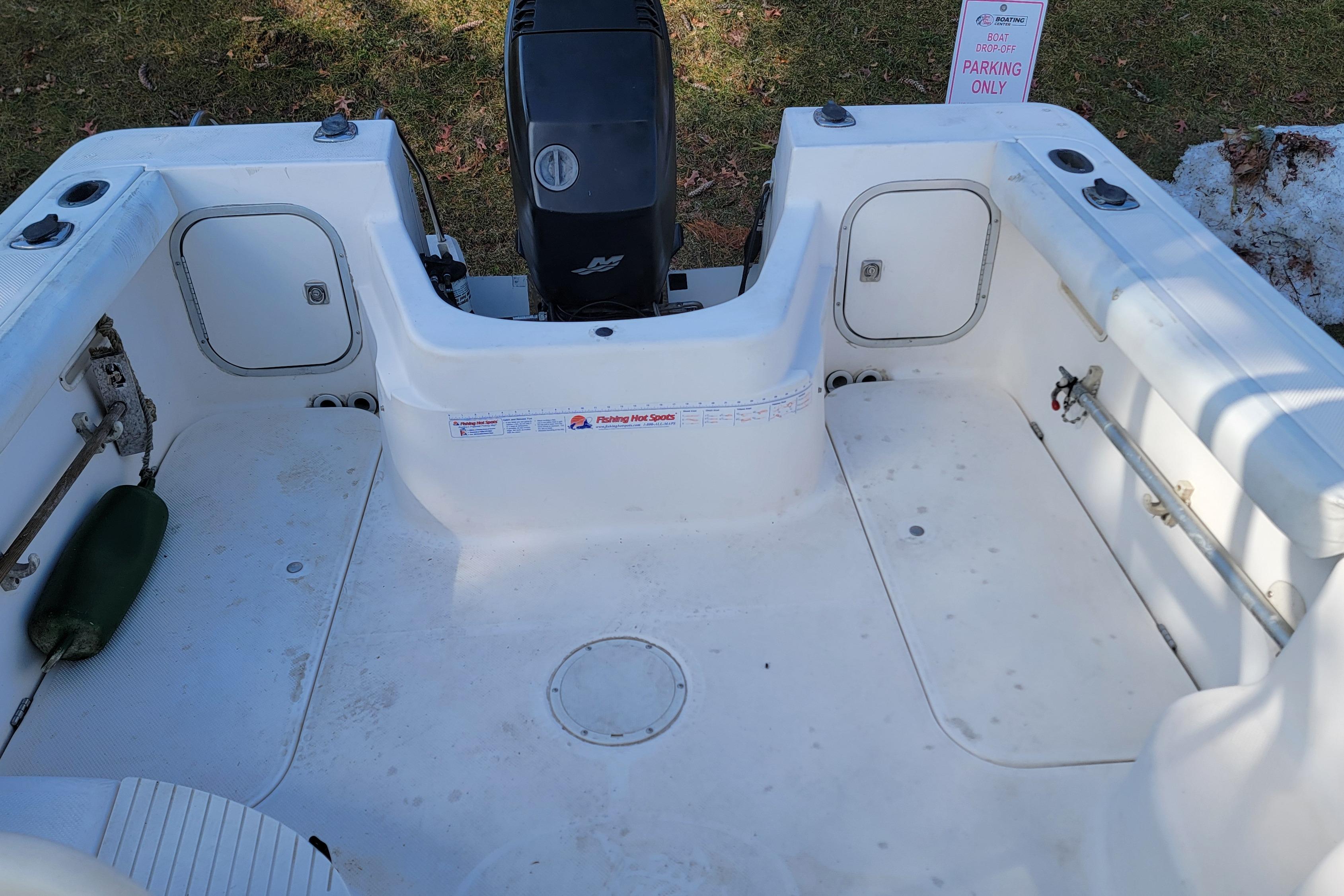 2003 Trophy 2002 Walkaround boat interior with engine and storage compartments.